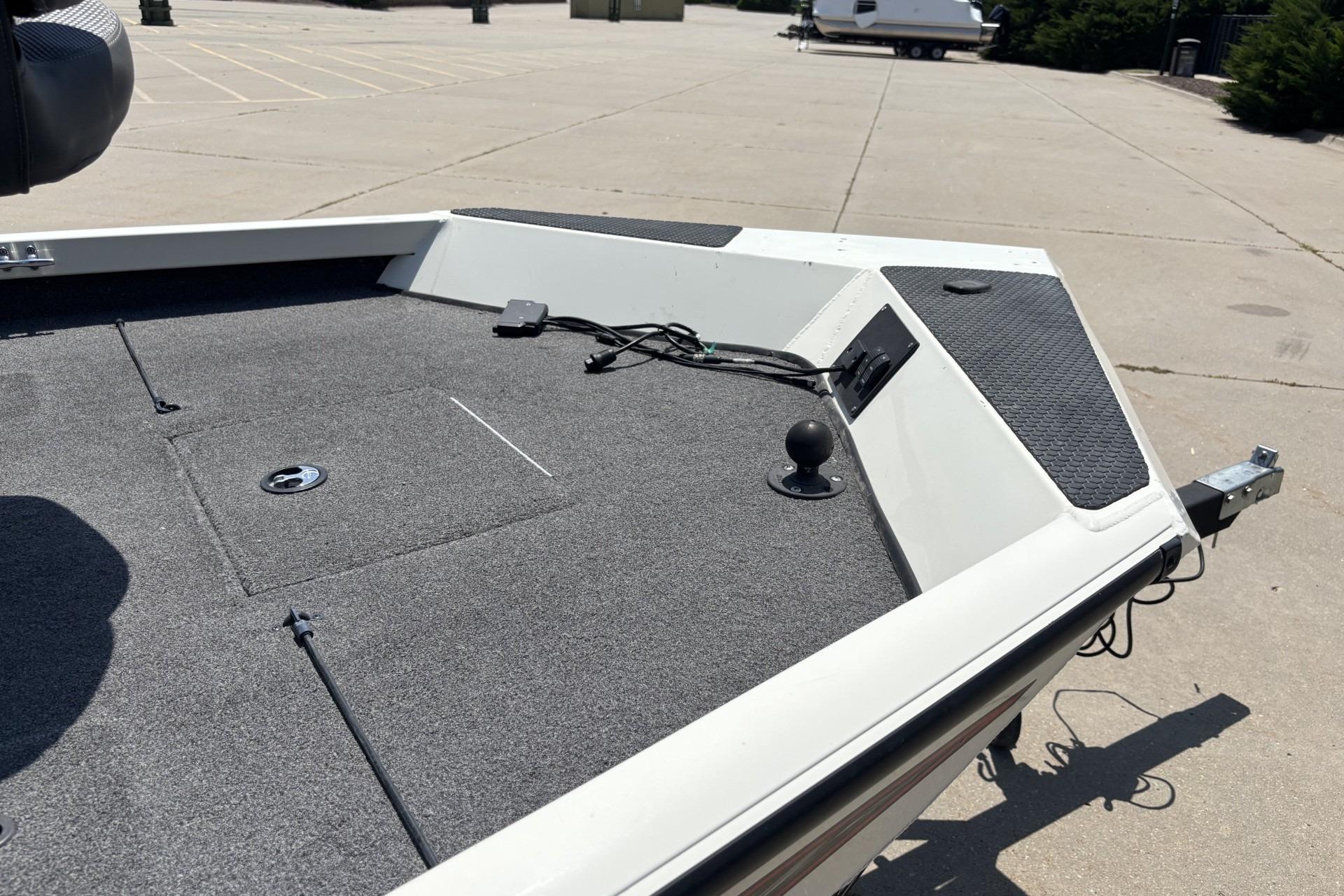 2017 Ranger RT178C boat deck with carpeted surface and trailer hitch in parking lot.