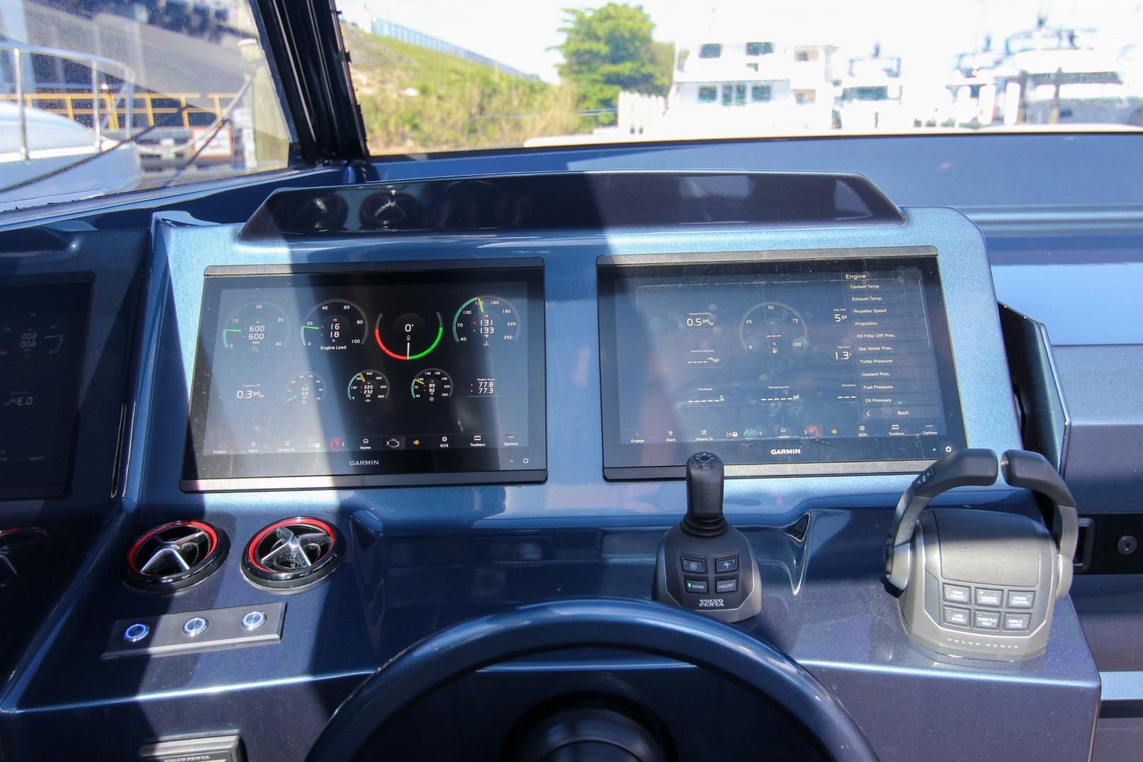 Cockpit of 2022 Vanquish Yachts VQ45 with dual Garmin displays and controls.