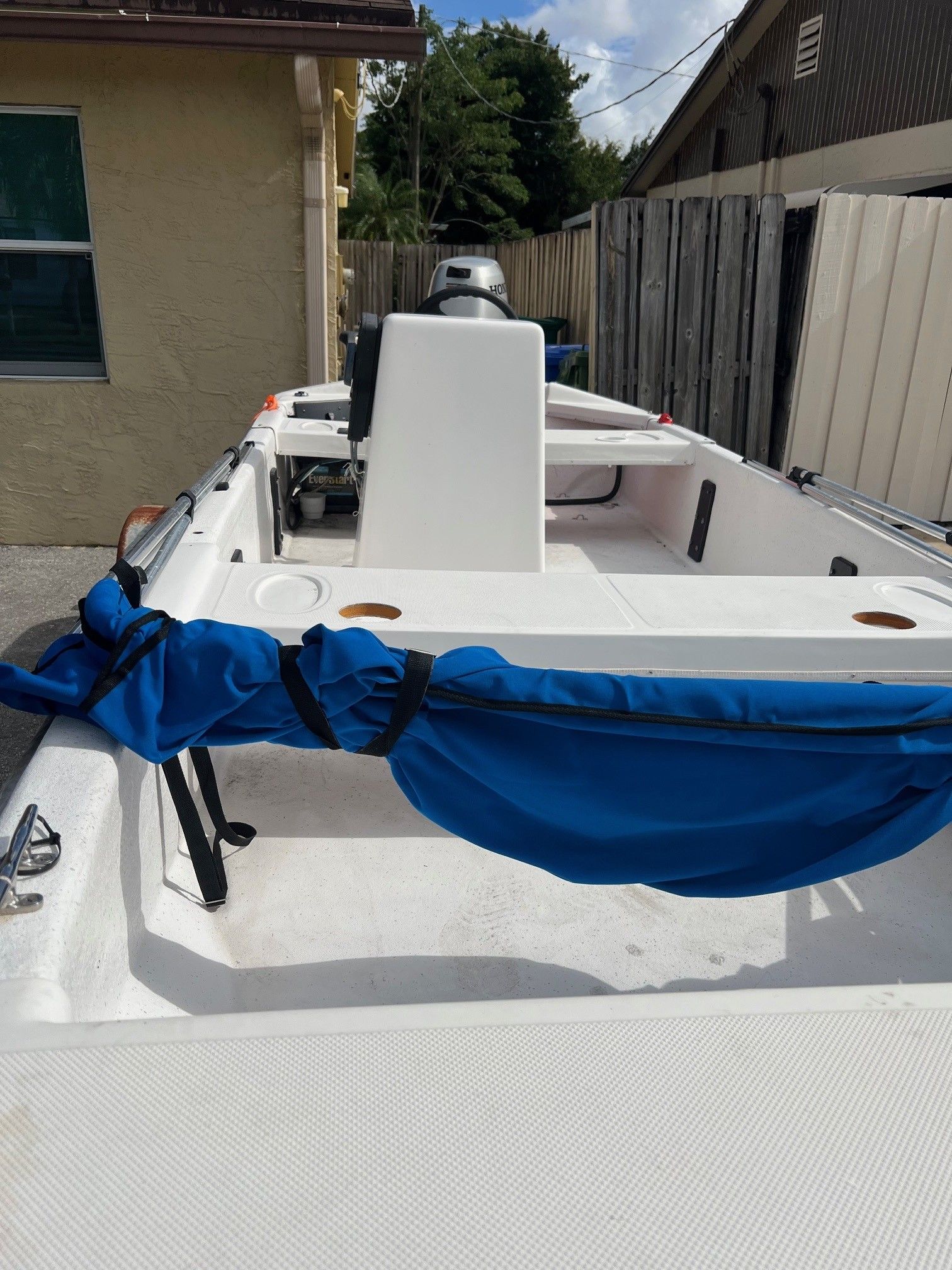 2007 Carolina Skiff JV15 boat with blue cover, side view.