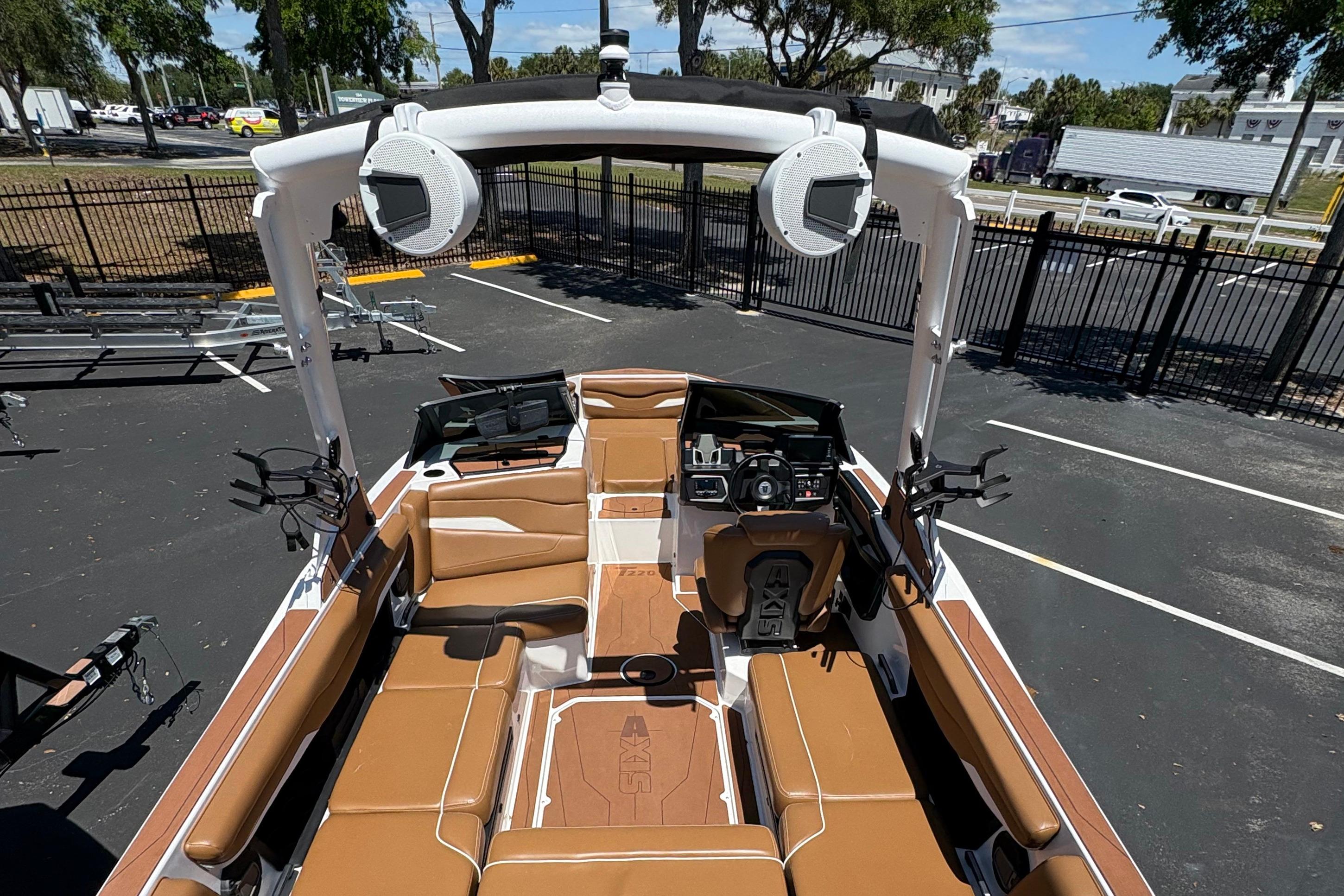 2025 Axis T220 boat interior with brown seating and advanced dashboard features.