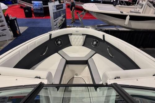 2026 Regal 21 OBX boat interior with spacious seating and modern design at a boat show.