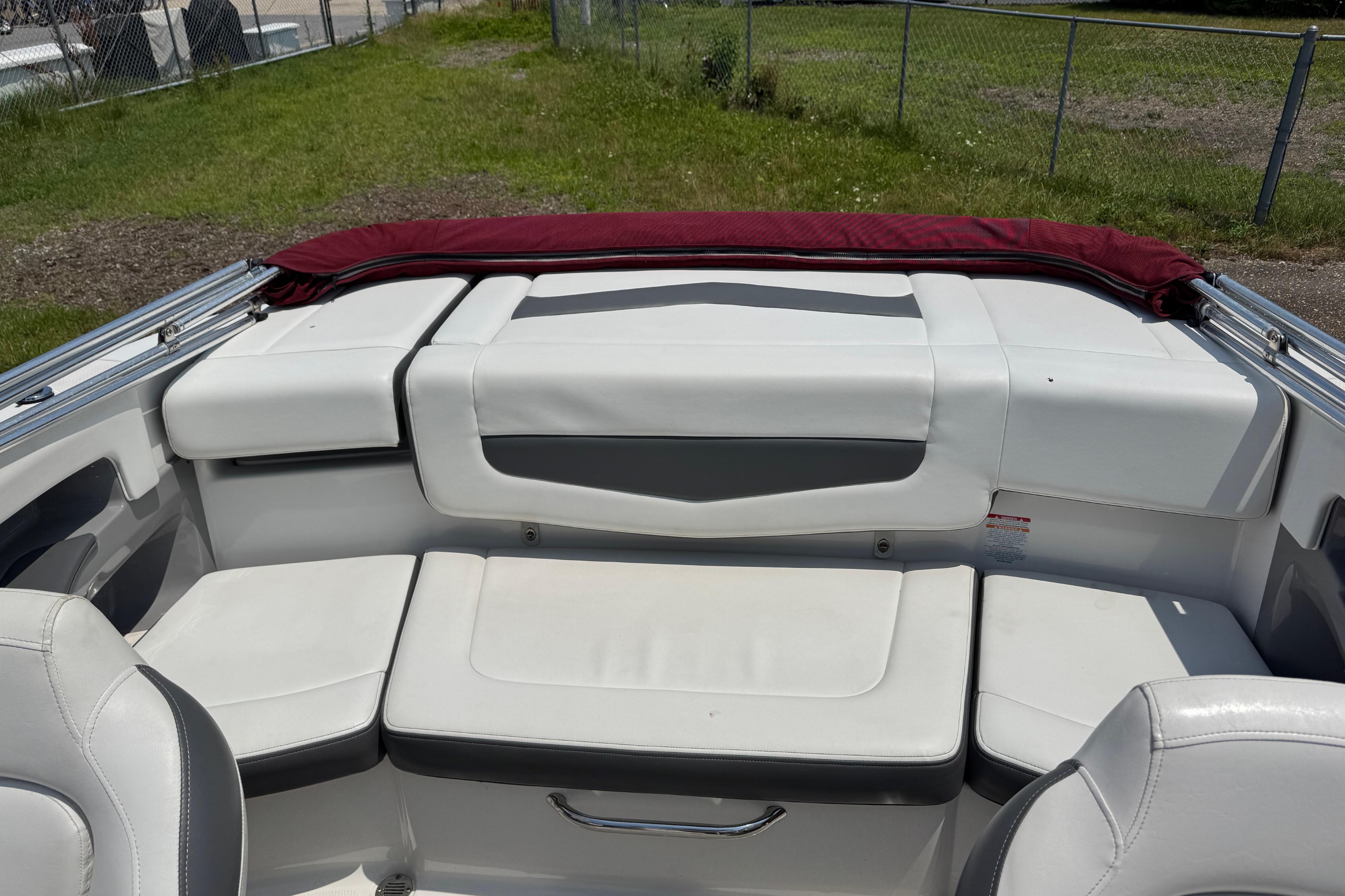 2013 Chaparral 196 SSi boat interior with white seating and maroon cover.