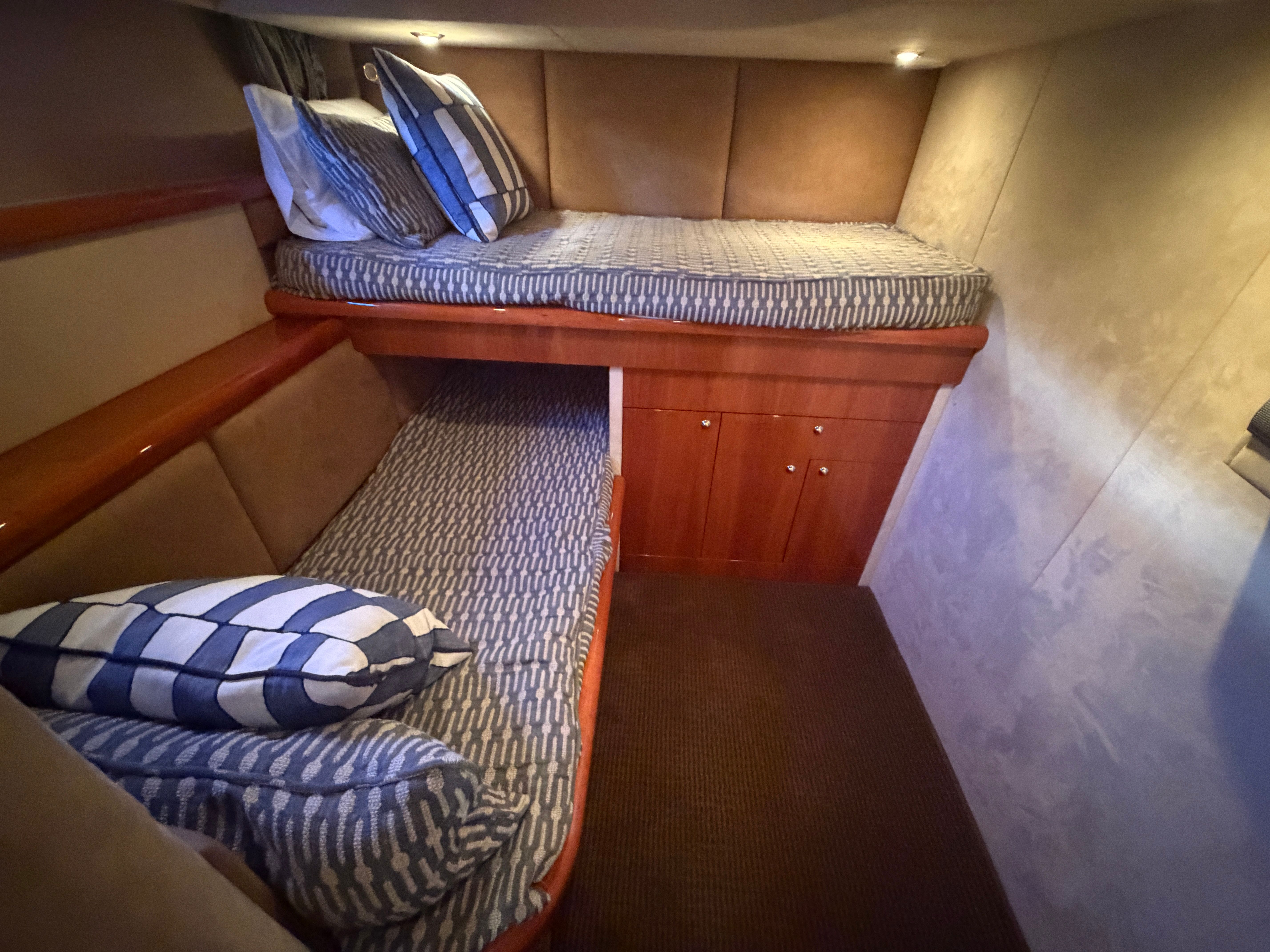 Interior of the Sunseeker Portofino 53 with two bunk beds and cozy lighting.