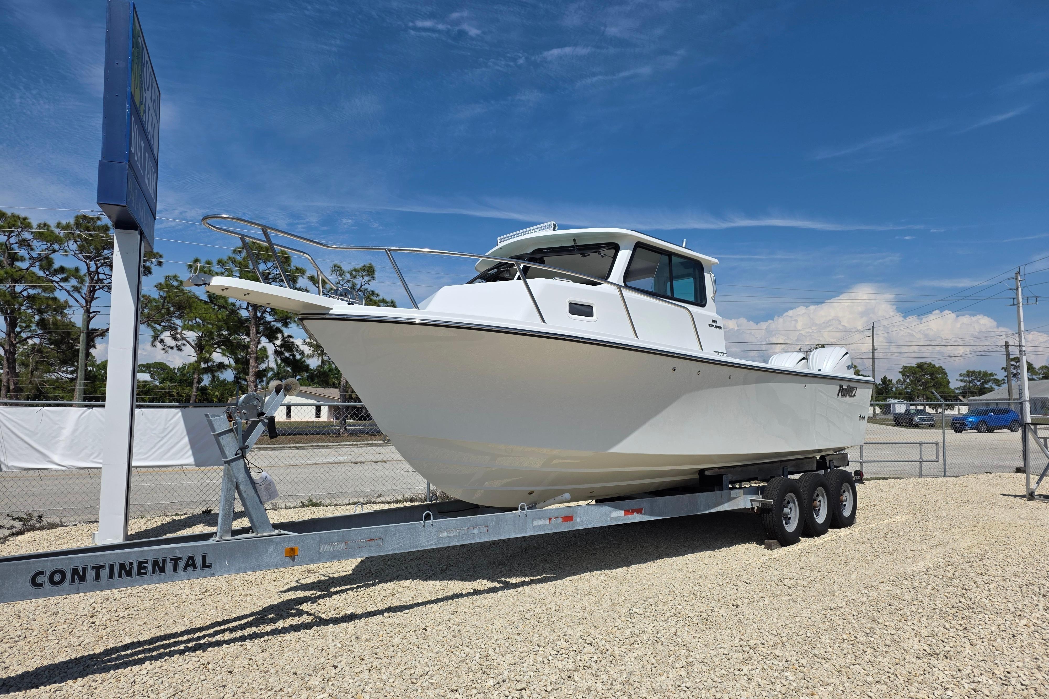 2026 Parker 287 Explorer boat on trailer under clear blue sky.