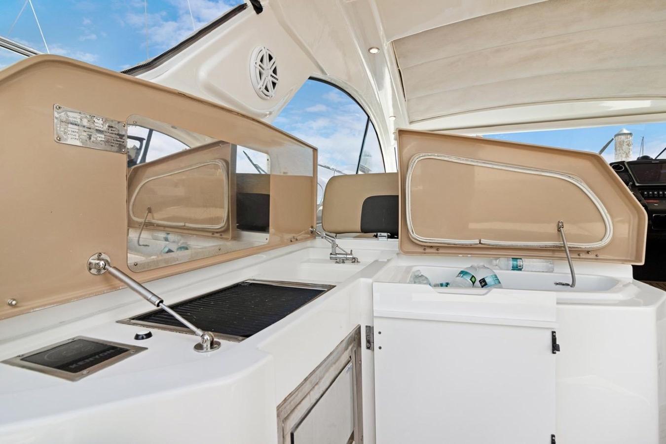 Interior view of 2016 Azimut Atlantis 43 yacht kitchen area with open storage compartments.