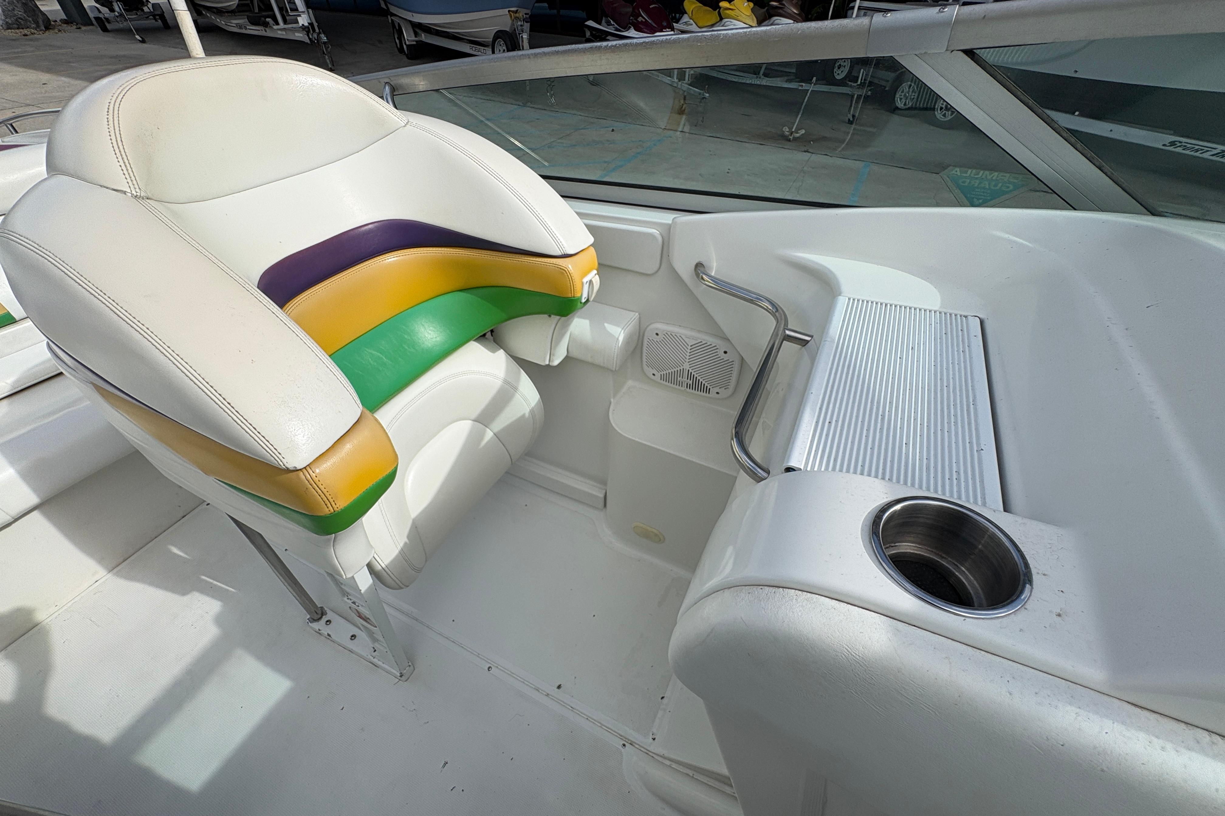 2002 Formula 292 FASTech boat interior with colorful seating and cup holder.