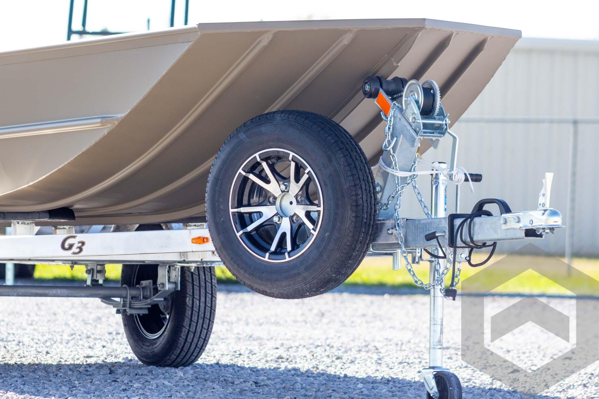 2026 G3 Gator Tough 1652 VBW boat on trailer, close-up of wheel and hitch.