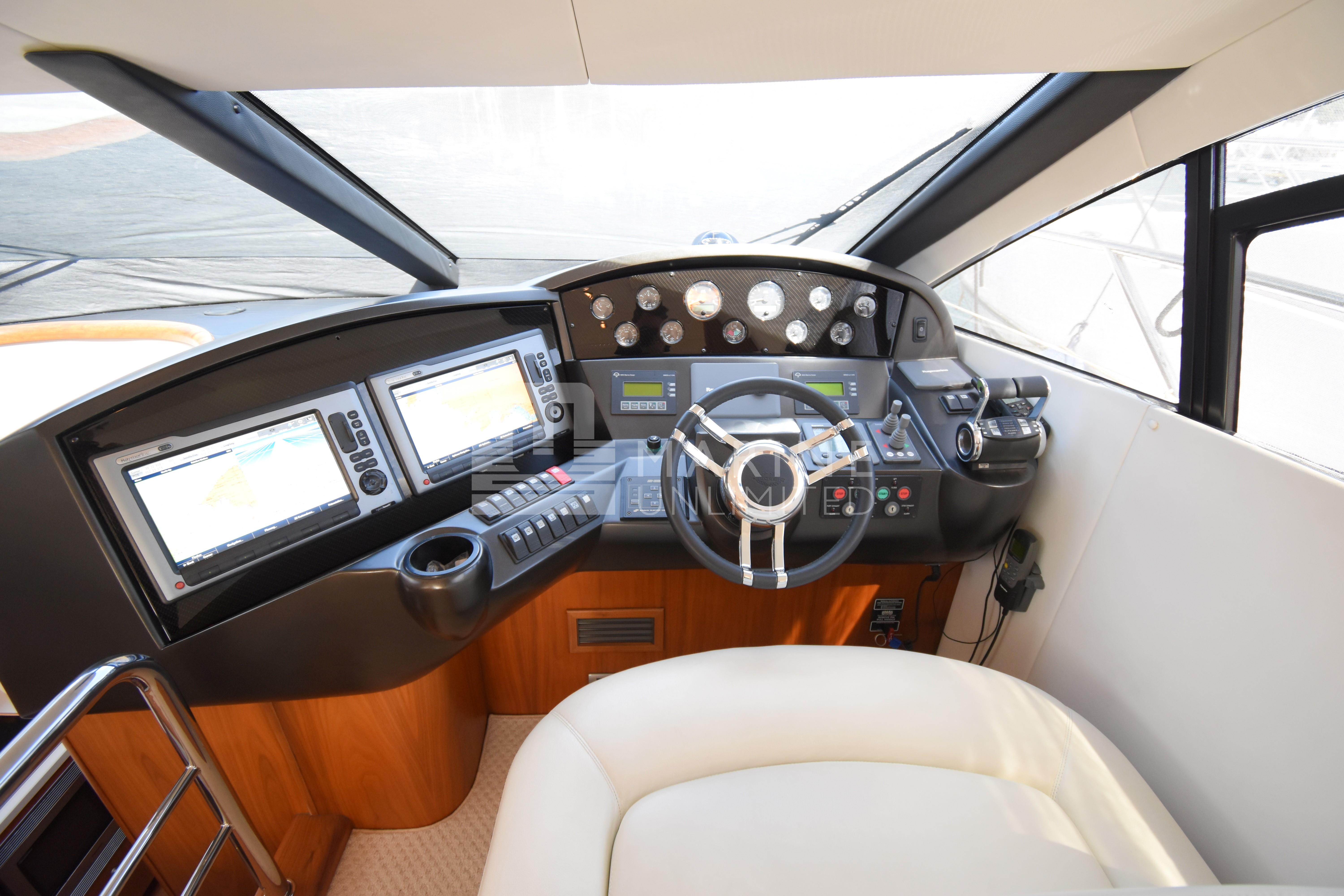 Cockpit of 2010 Sunseeker Manhattan 52 yacht with modern navigation equipment and steering wheel.