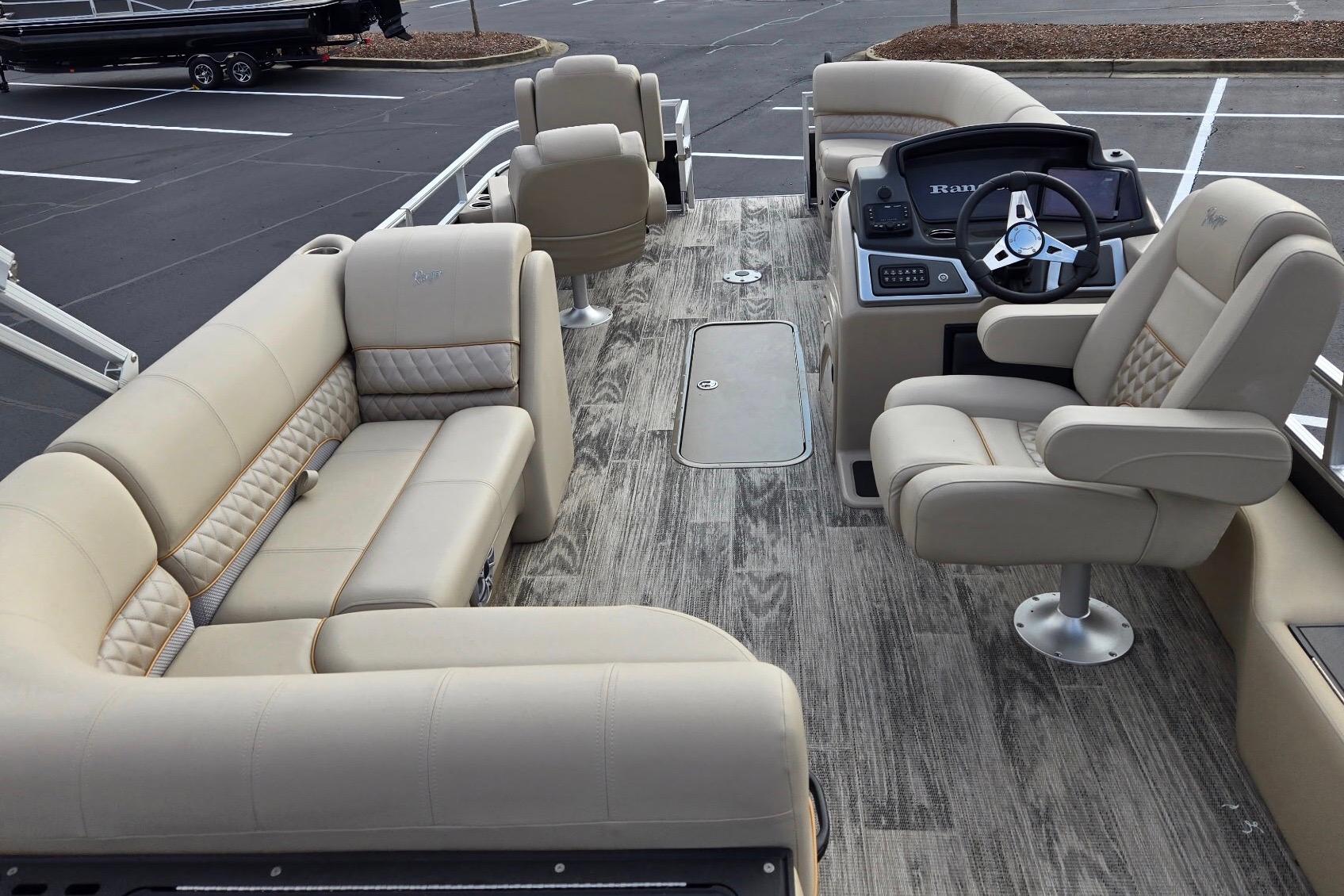 2025 Ranger Reata 223FC boat interior with beige seating and modern helm.