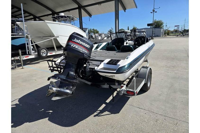 1997 Javelin 389 FS boat with Johnson 175 Fast Strike outboard motor on trailer.