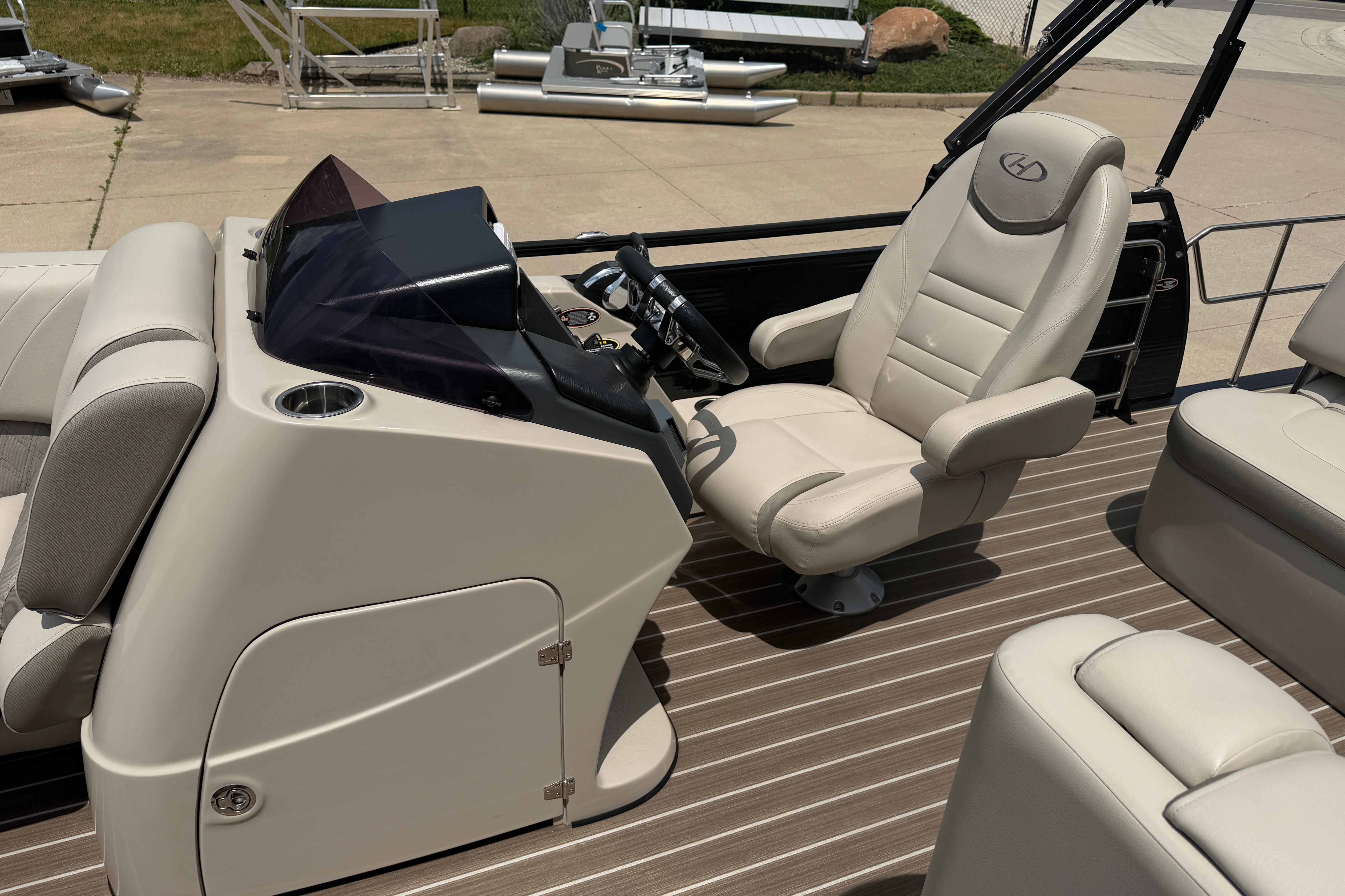 2019 Harris Solstice 240 boat interior with captain's chair and control console.
