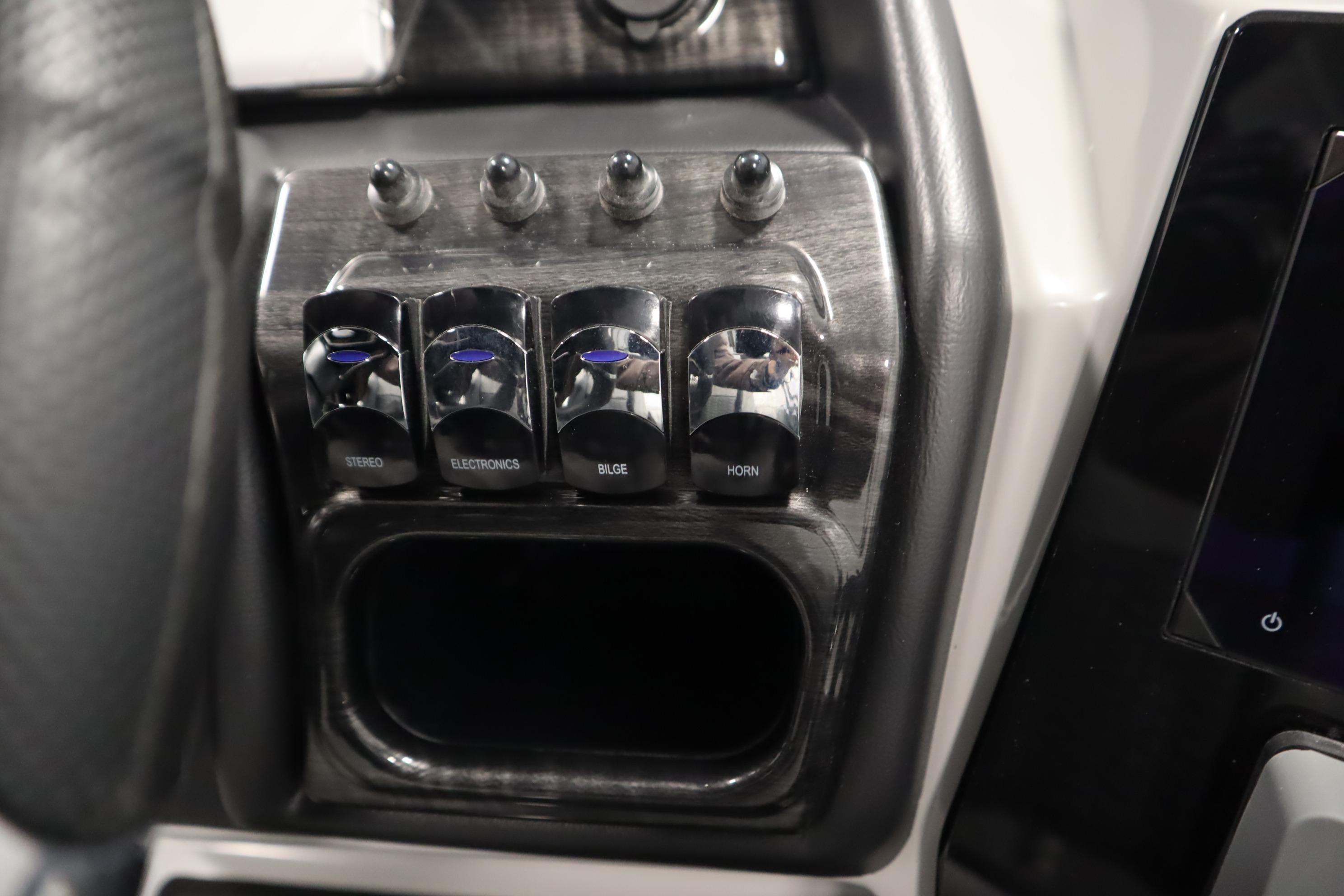 Control panel of 2025 Bentley Pontoons Elite 253 Admiral Tri-toon with labeled switches.
