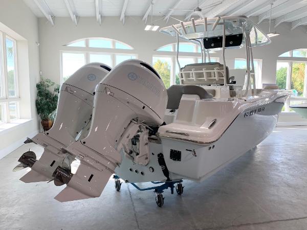 2024 Key West 263 FS boat with twin outboard engines in showroom.