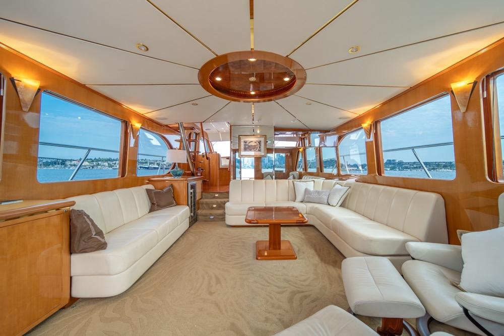 Luxurious interior of 2005 Ocean Alexander 64 Motoryacht with elegant seating and panoramic windows.
