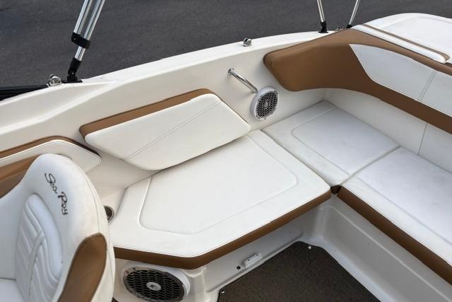2017 Searay SPX210 boat interior with white and brown seating, featuring built-in speakers.
