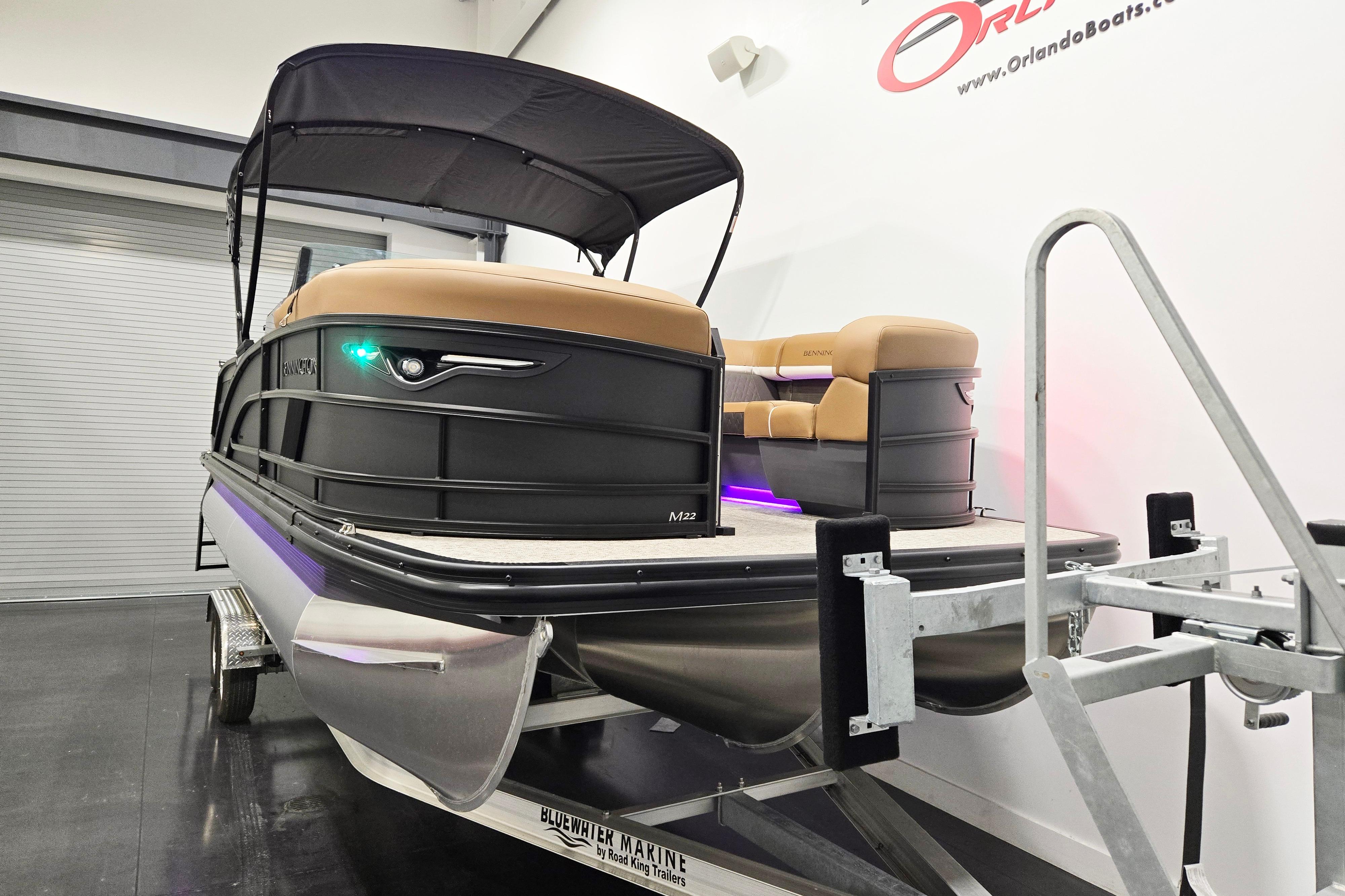 2026 Bennington 22 M Swingback pontoon boat on trailer in showroom.