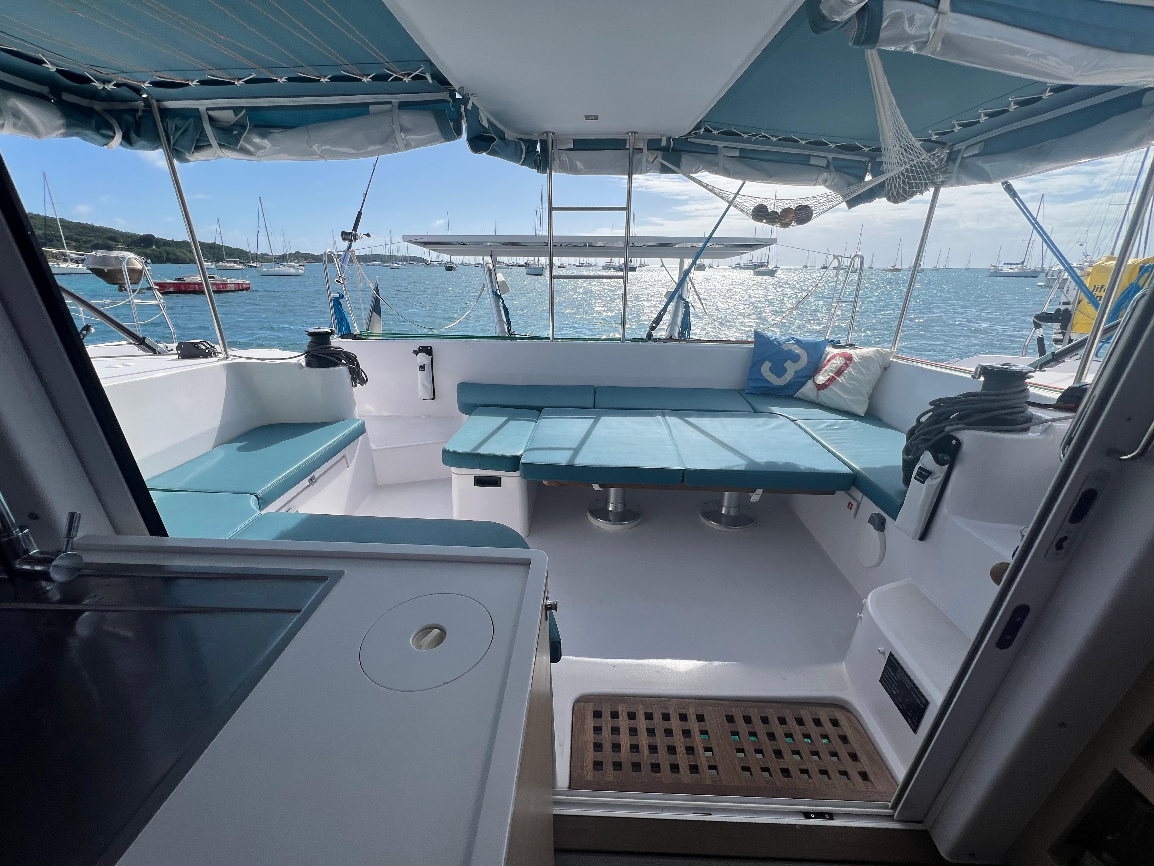 2024 Outremer 45 catamaran cockpit with blue seating, ocean view, and modern design.