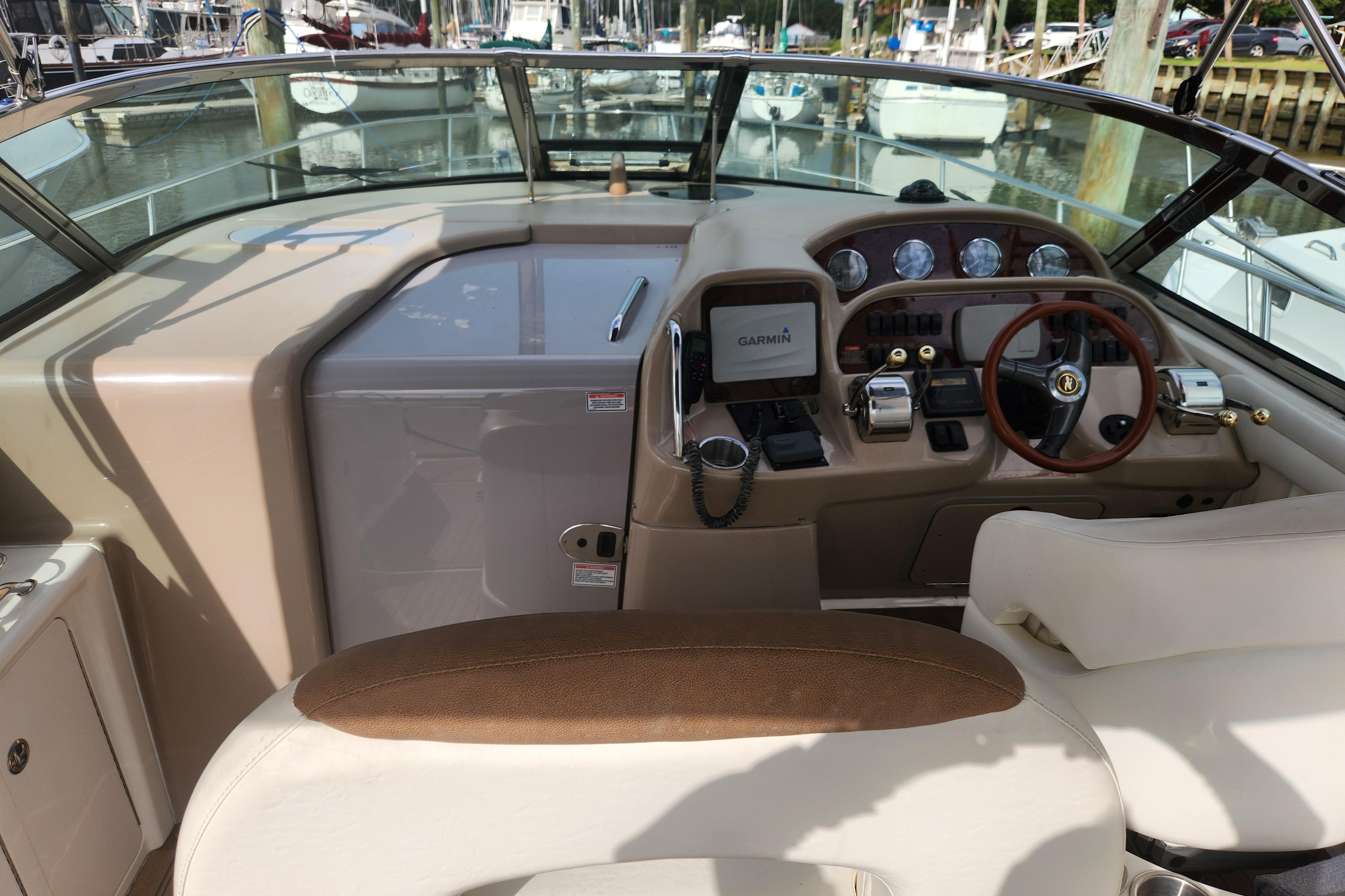 Cockpit of 2003 Sea Ray 360 Sundancer with Garmin navigation system and leather seating.