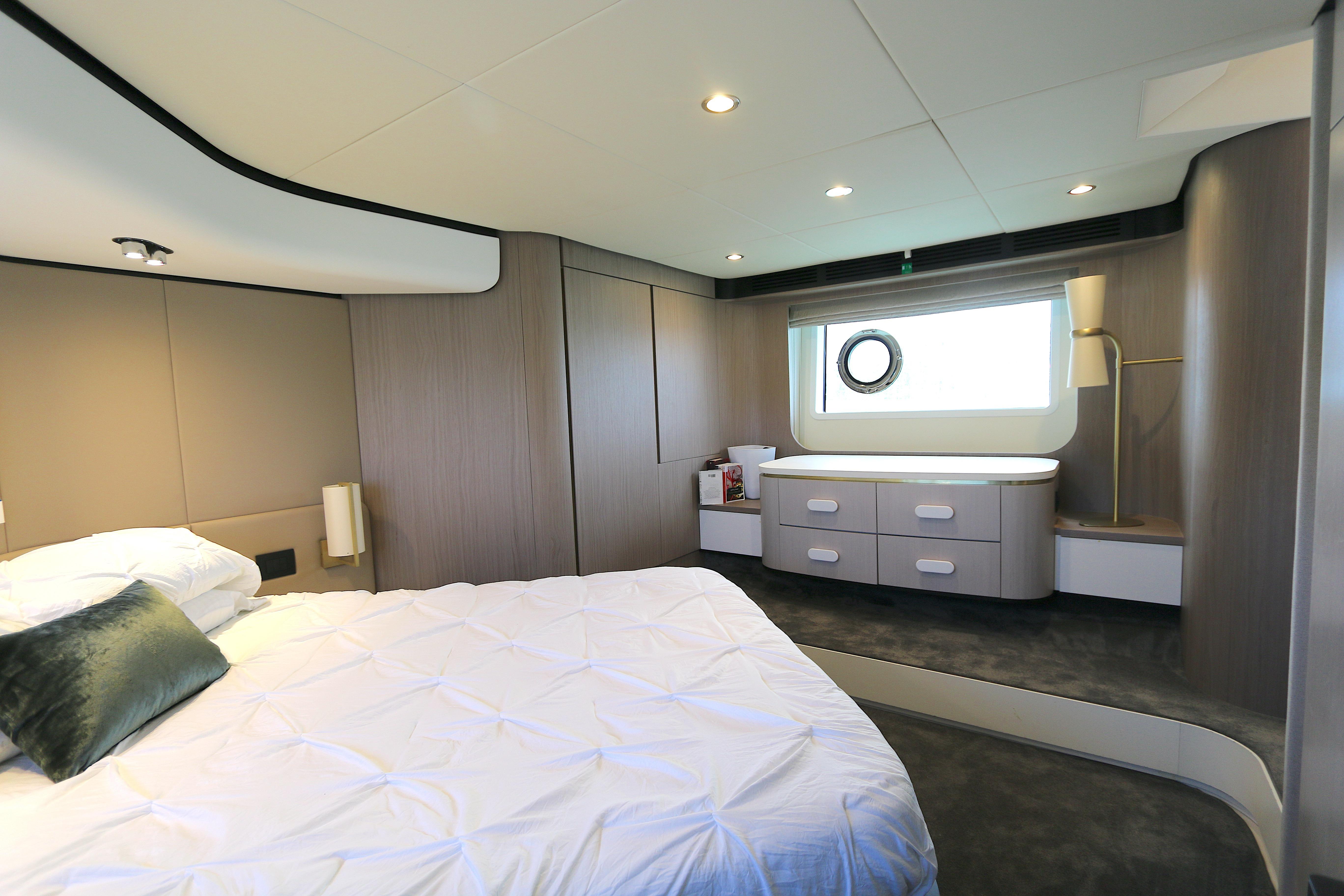 Luxurious bedroom interior of 2020 Azimut 55 yacht with modern design and elegant furnishings.