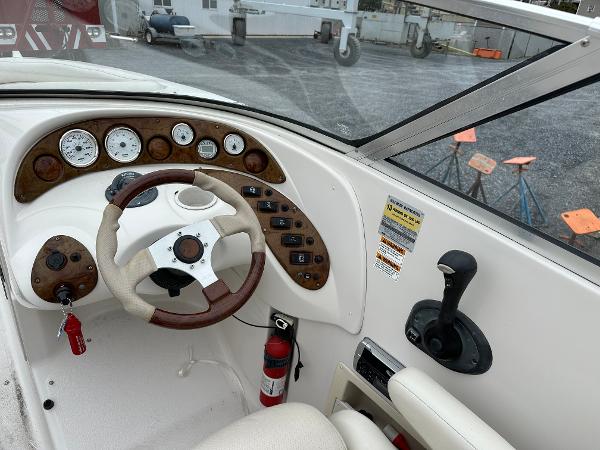 2004 Starcraft Aurora 2410 boat dashboard with steering wheel and control panel.