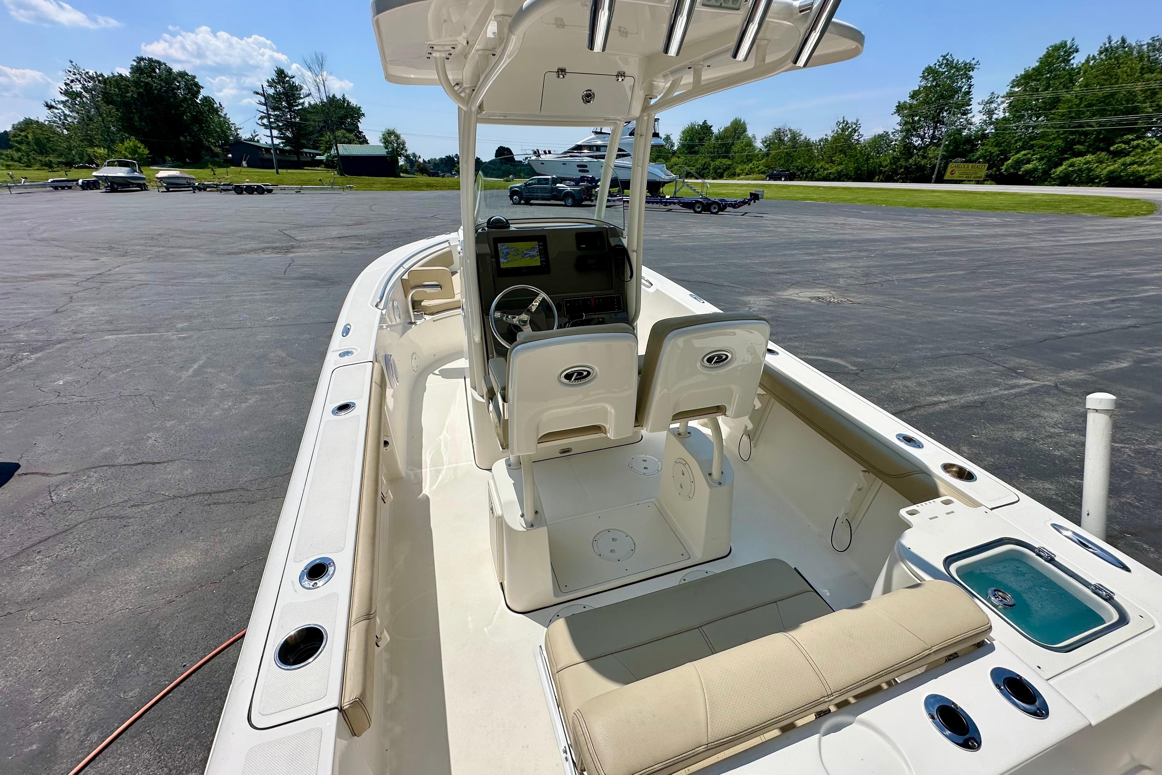 2020 Pursuit C 238 Center Console boat with seating and console, parked outdoors.