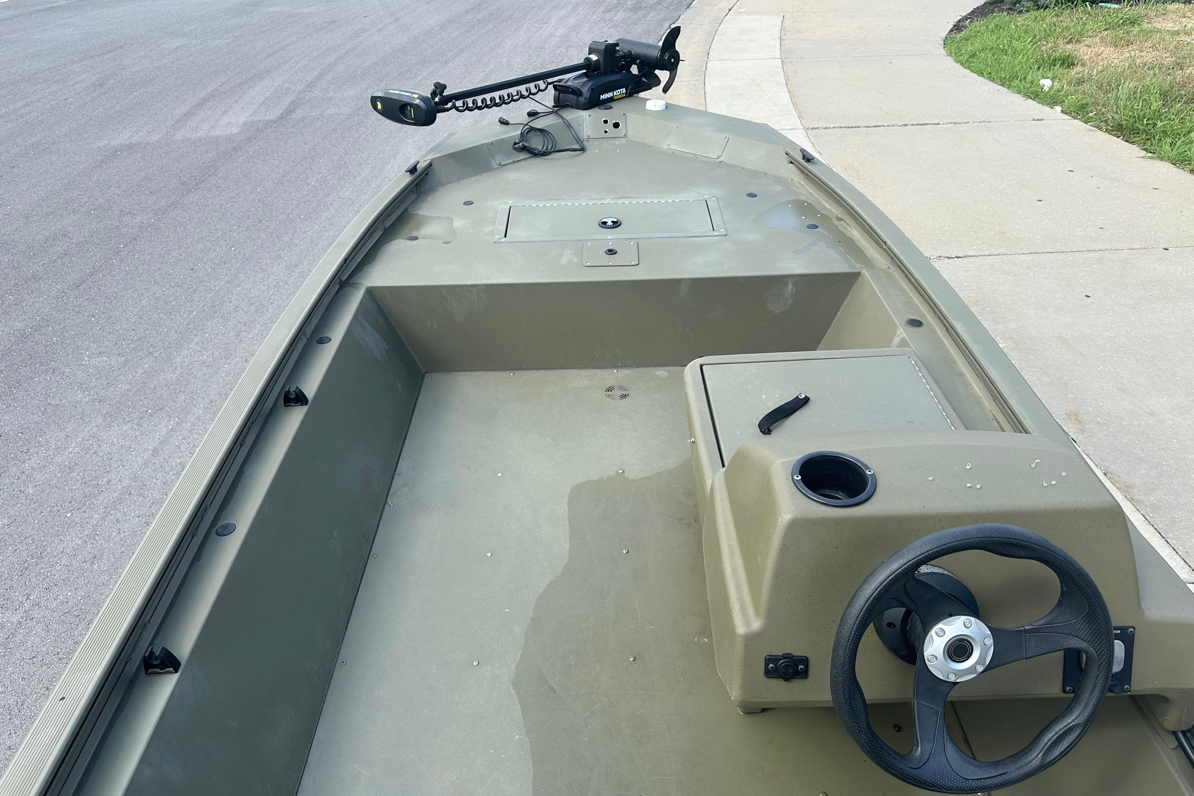2024 Tracker Grizzly 1648 SC boat interior with steering wheel and storage compartments.