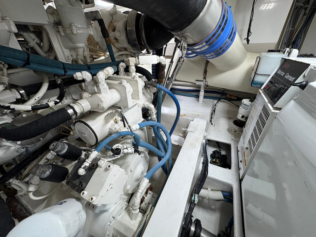 Engine room of a 2007 Viking 52 Convertibles yacht, showcasing complex machinery and piping.