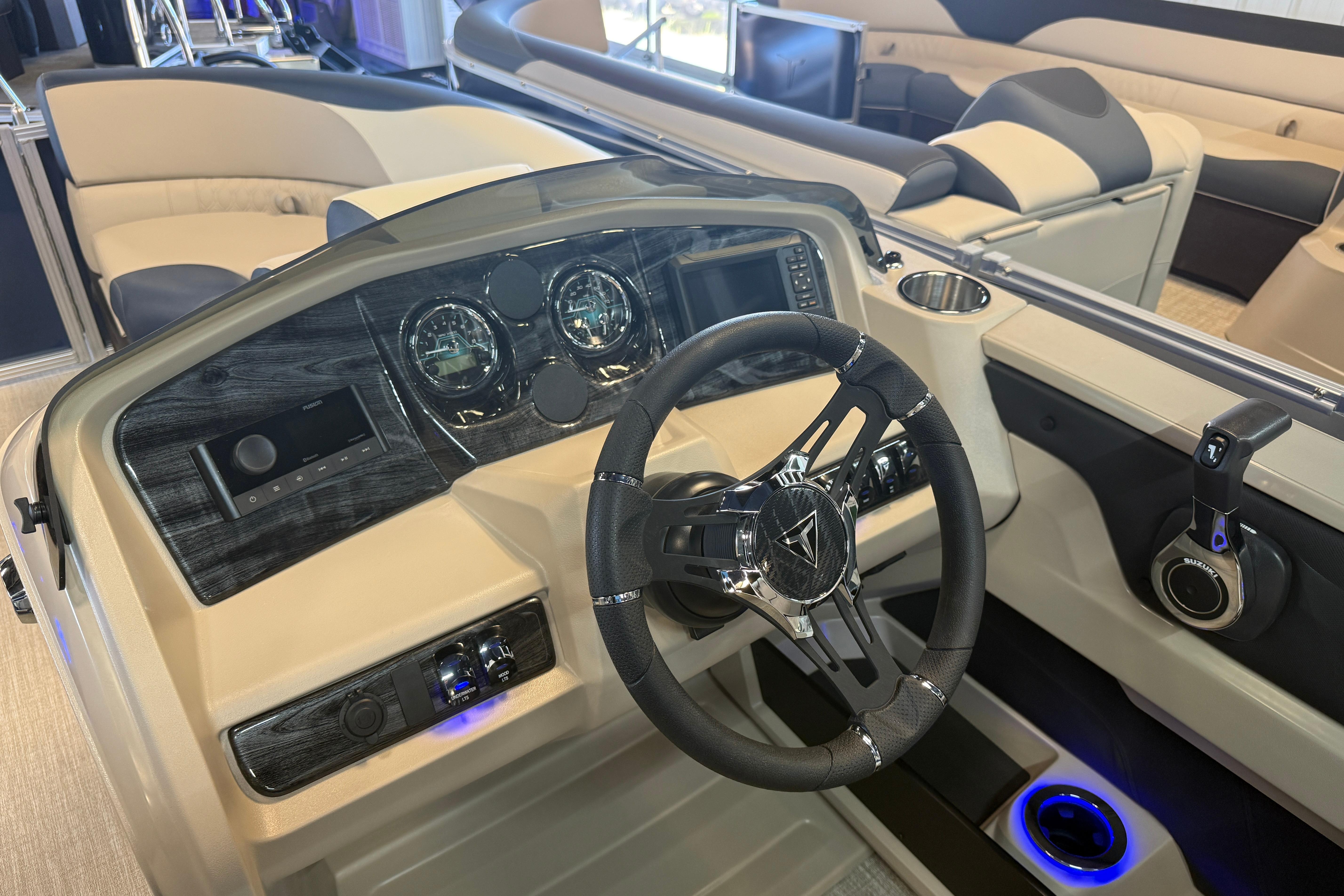 2026 Tahoe Pontoon LTZ Quad Lounger Shift dashboard with steering wheel and controls.