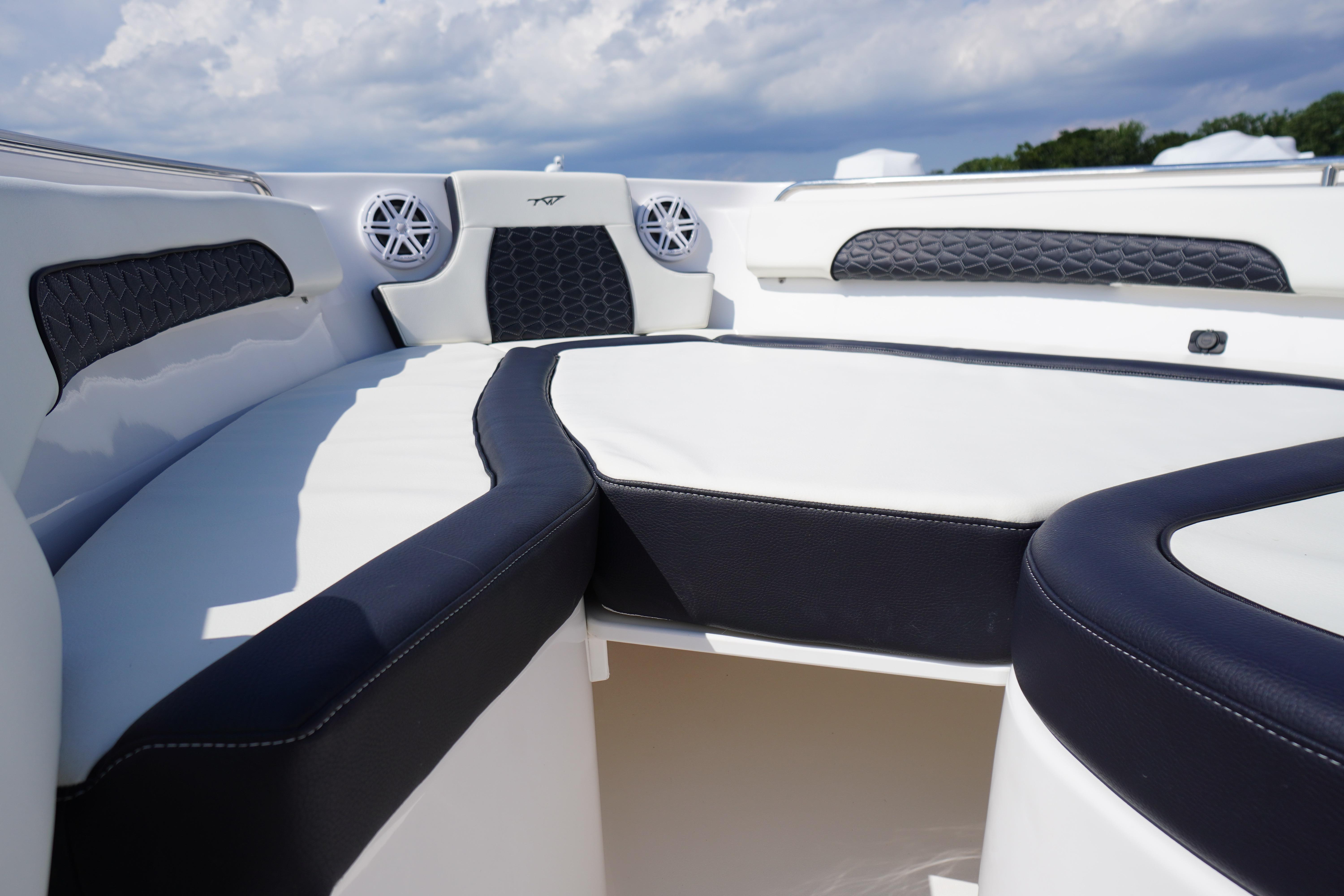 2025 Tidewater 232 SS boat interior with cushioned seating and speaker system.