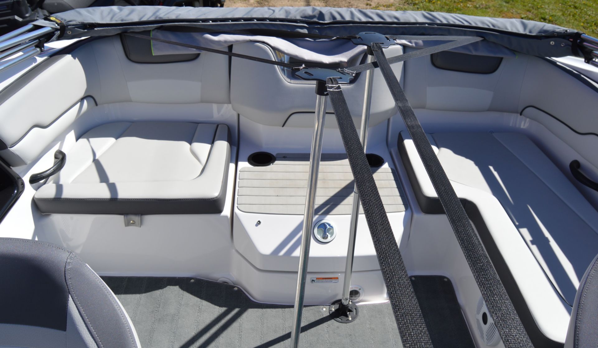 Interior of a Yamaha SX190 boat with white seating and gray flooring.