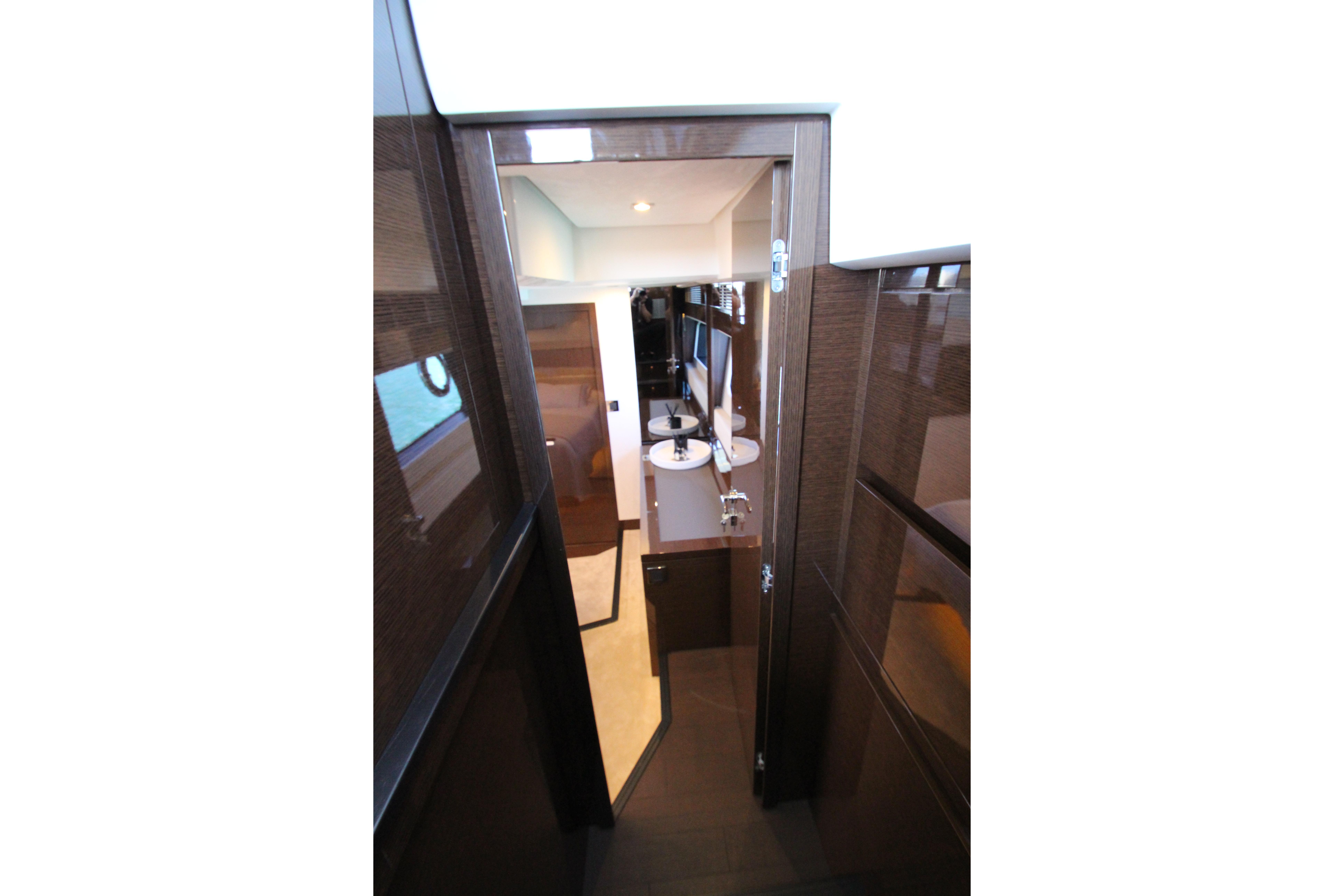 Interior view of 2022 Prestige 520 yacht, featuring sleek wood finishes and modern design.