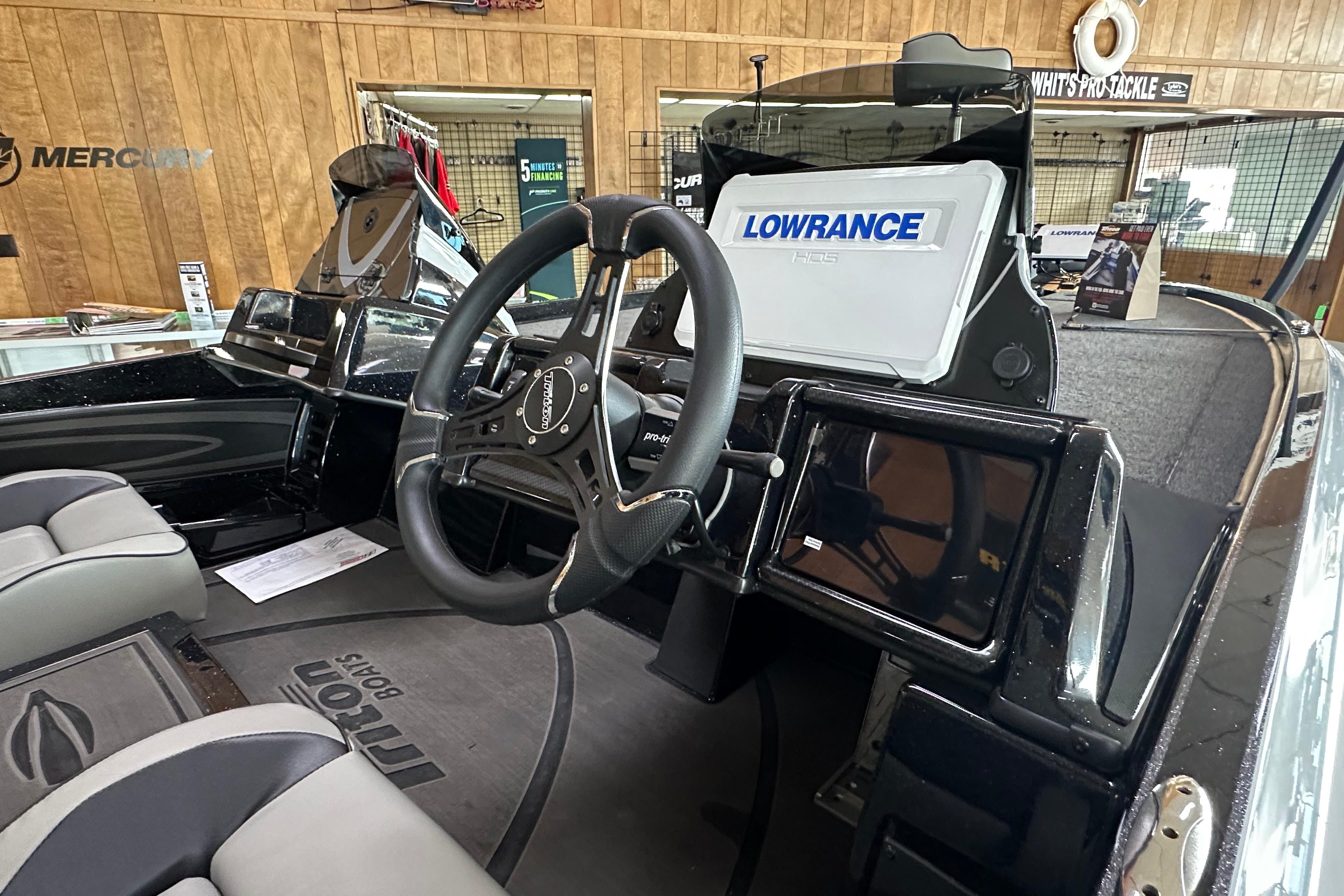 2024 Triton 20XP Patriot boat interior with steering wheel and Lowrance electronics.