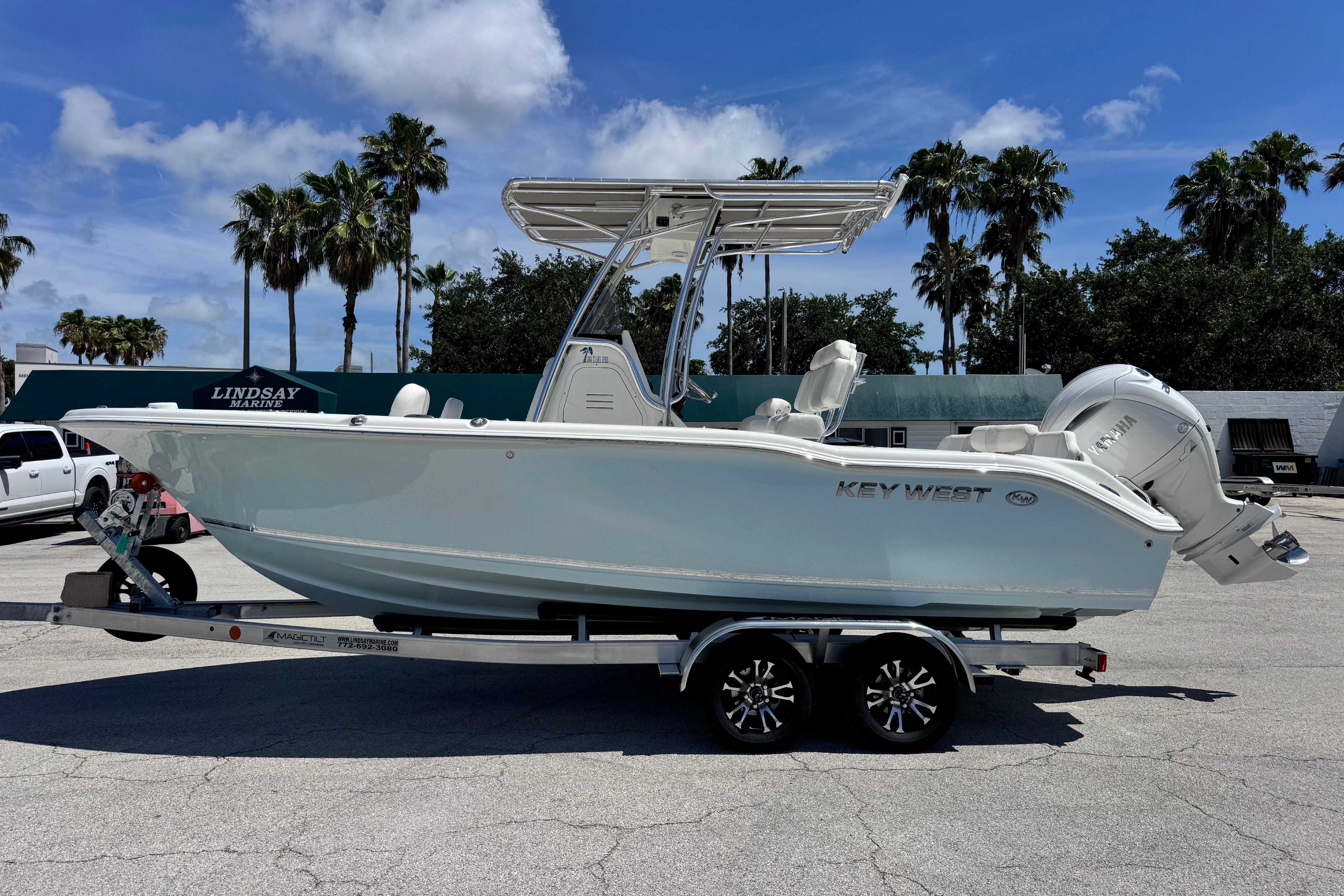 2026 Key West 219 FS boat on trailer, parked outdoors under a clear sky.