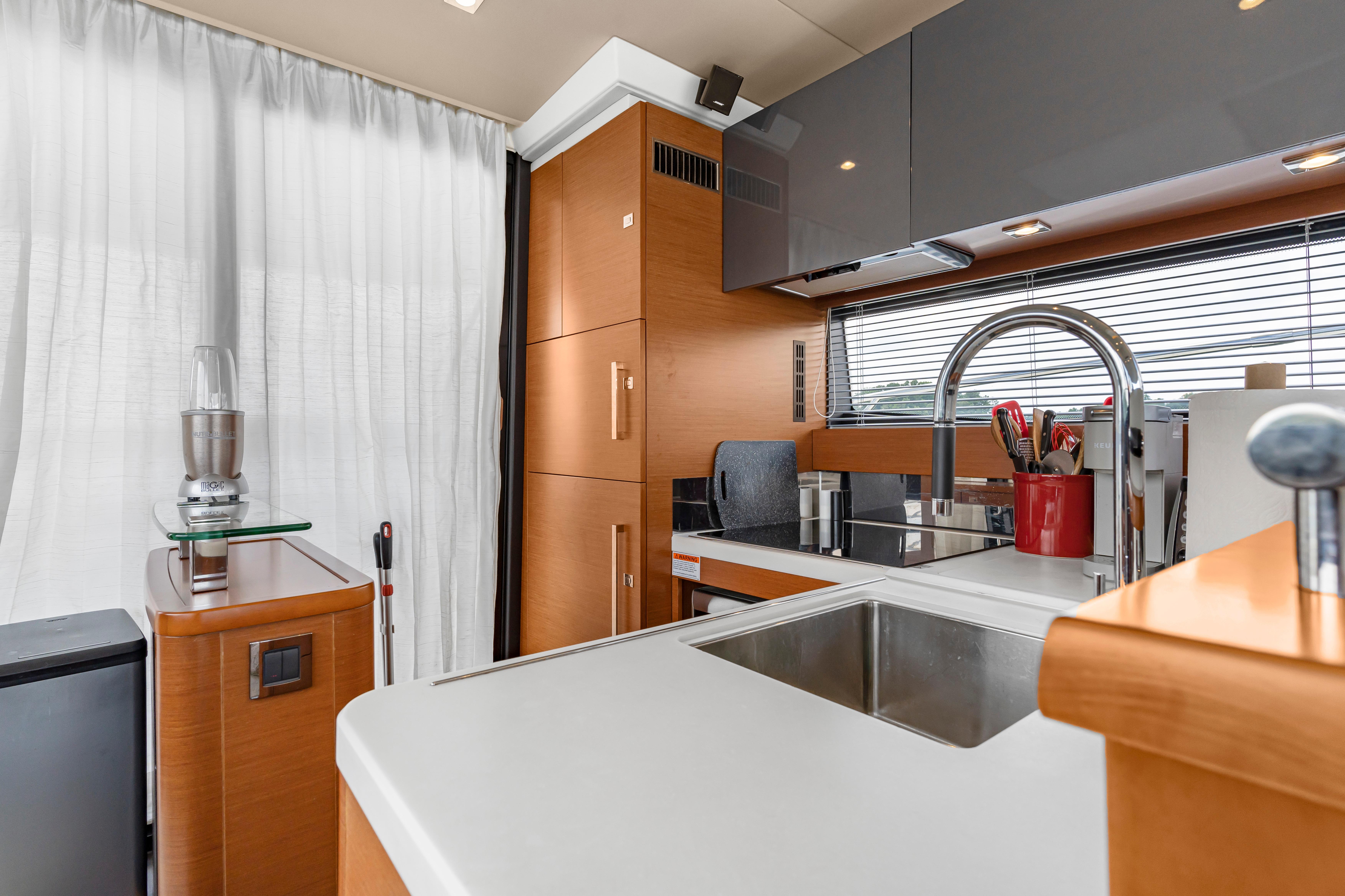 Modern kitchen interior of 2017 Prestige 500 yacht with sleek design and stainless steel fixtures.