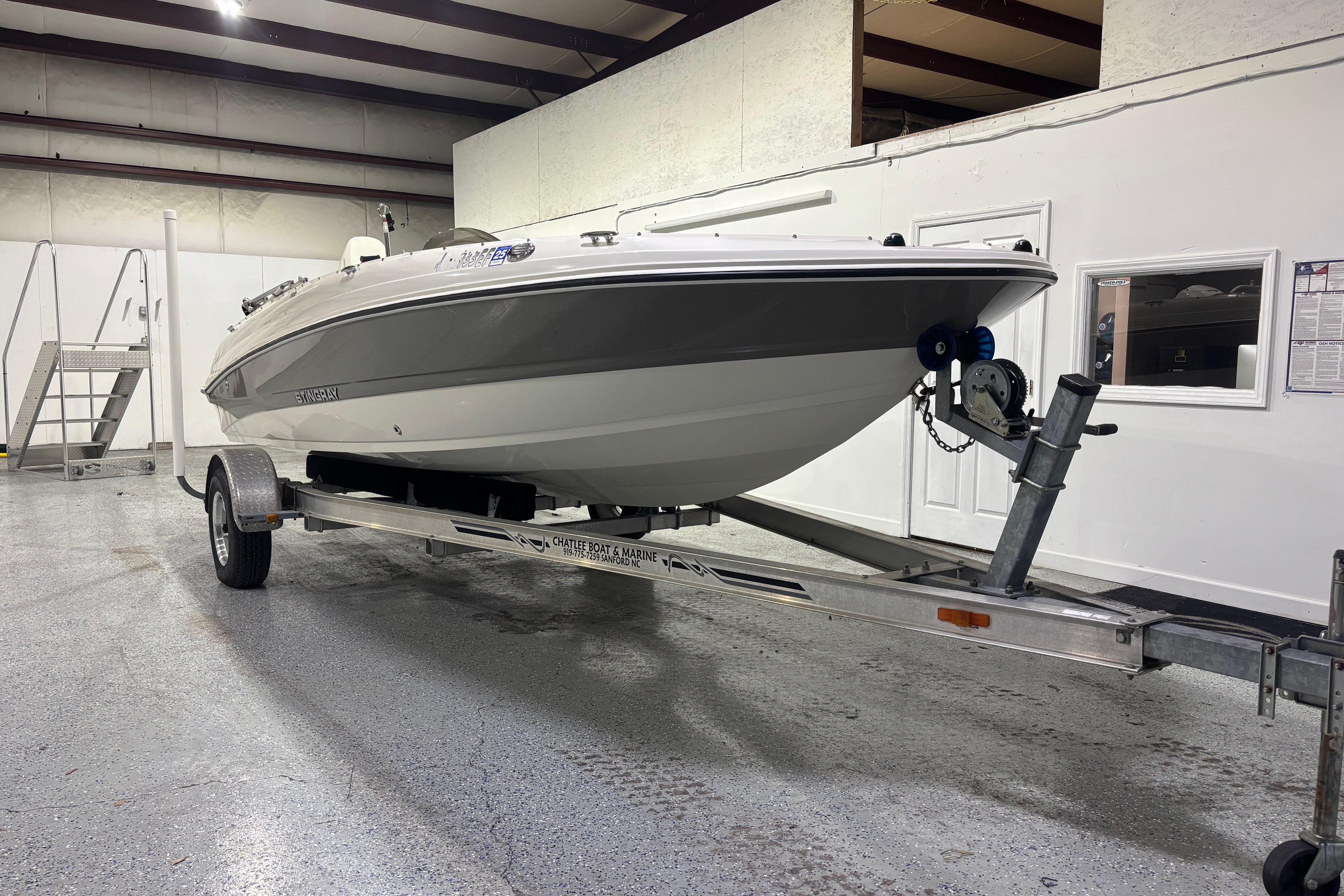 2017 Stingray 182 SC boat on trailer in indoor storage facility.
