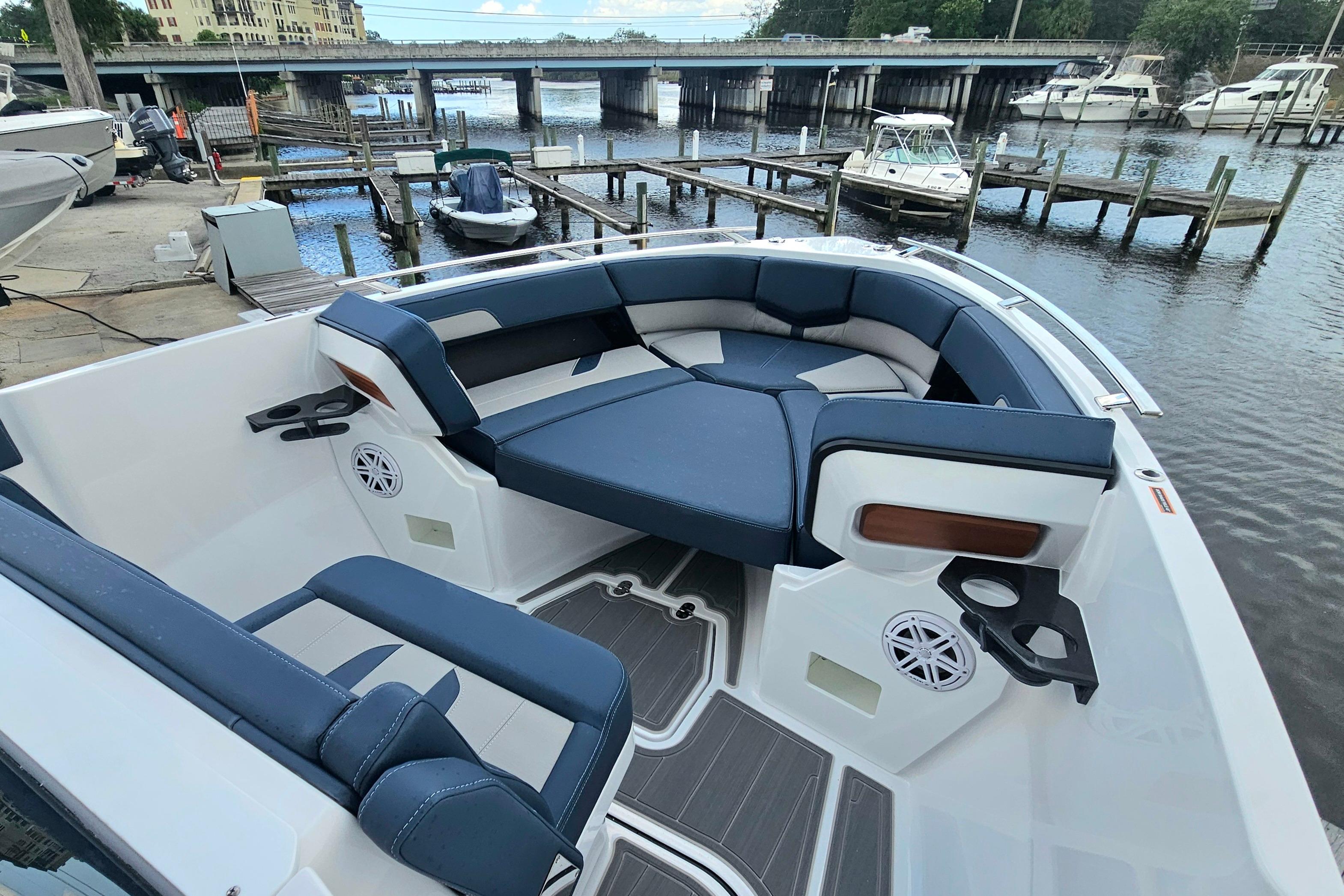 Luxurious seating on the 2026 Monterey Elite 27 OB boat docked by the waterfront.