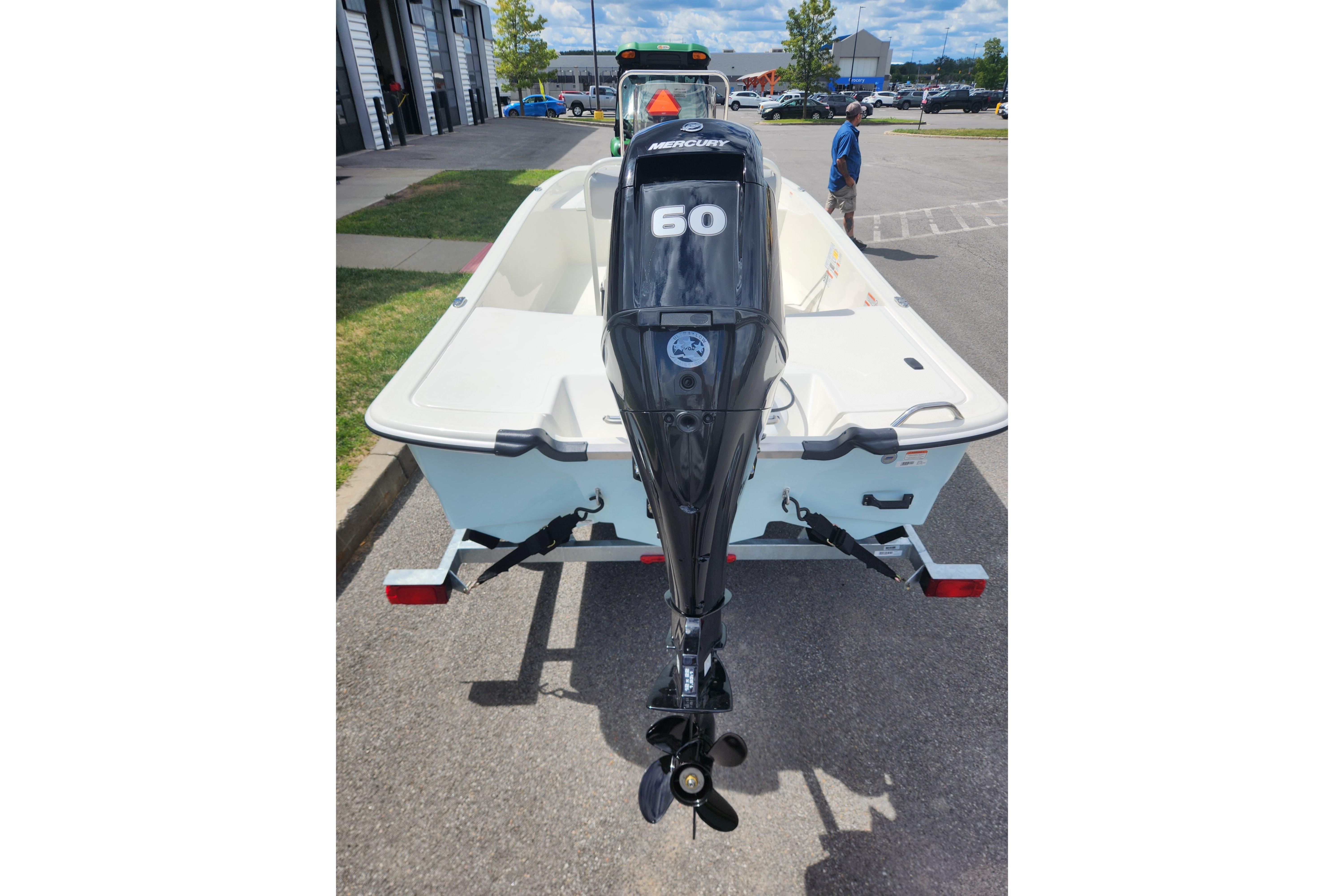 2026 Mako Pro Skiff 17 CC with Mercury 60 outboard motor, parked outdoors.