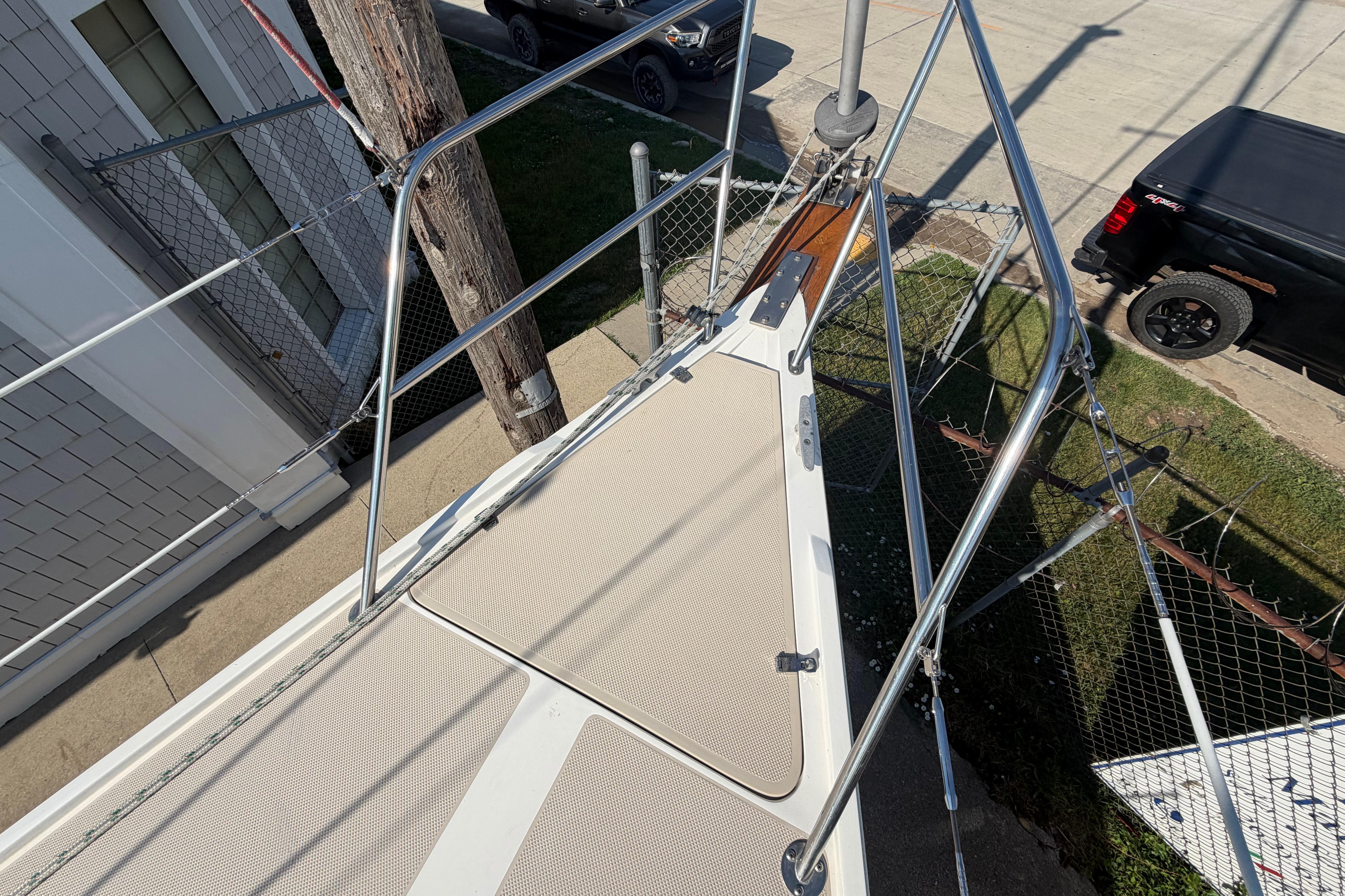 Bow of 1988 Catalina 30 MkII sailboat with stainless steel railings and deck details.