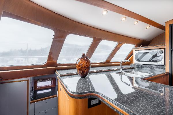 Luxurious interior of 2025 Shuttleworth 52 AeroRig yacht with sleek kitchen design.