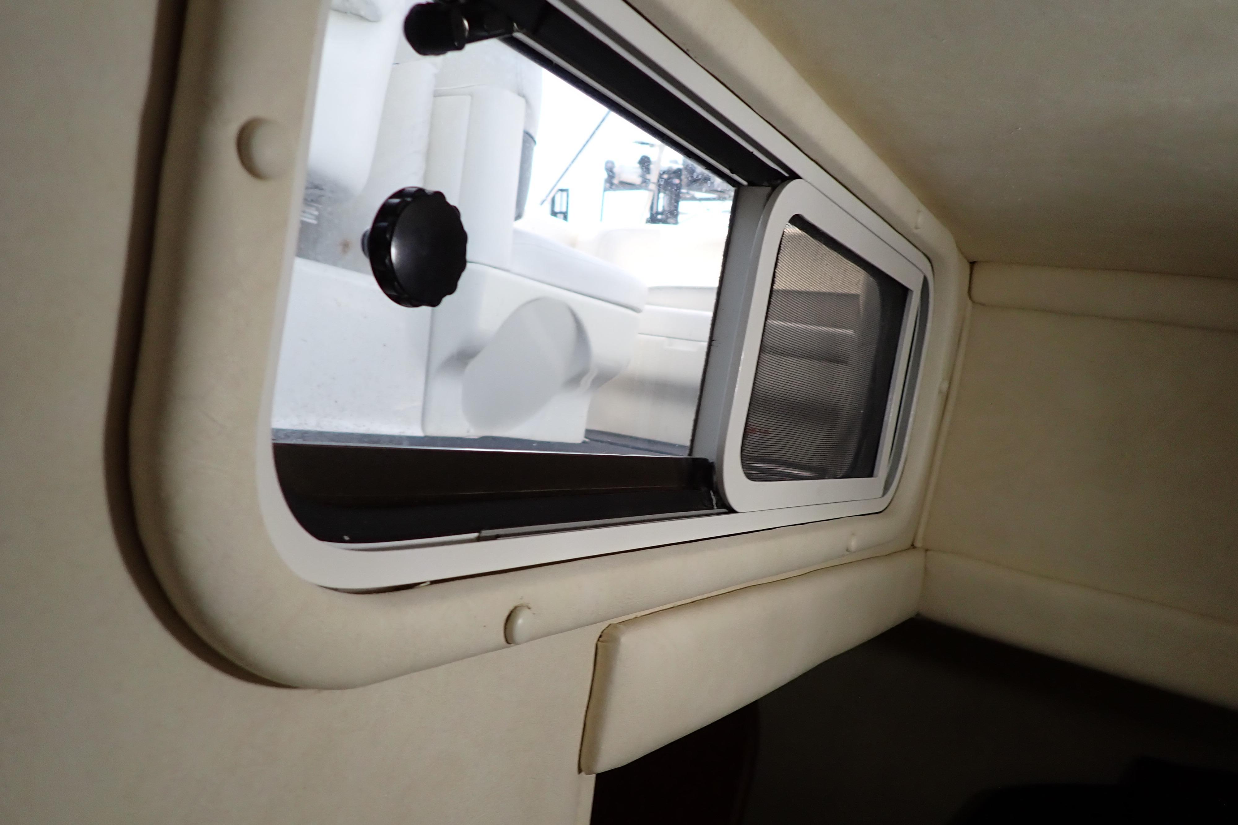 Interior cabin view of a 2005 Sea Ray Sundancer 260 boat with a window.