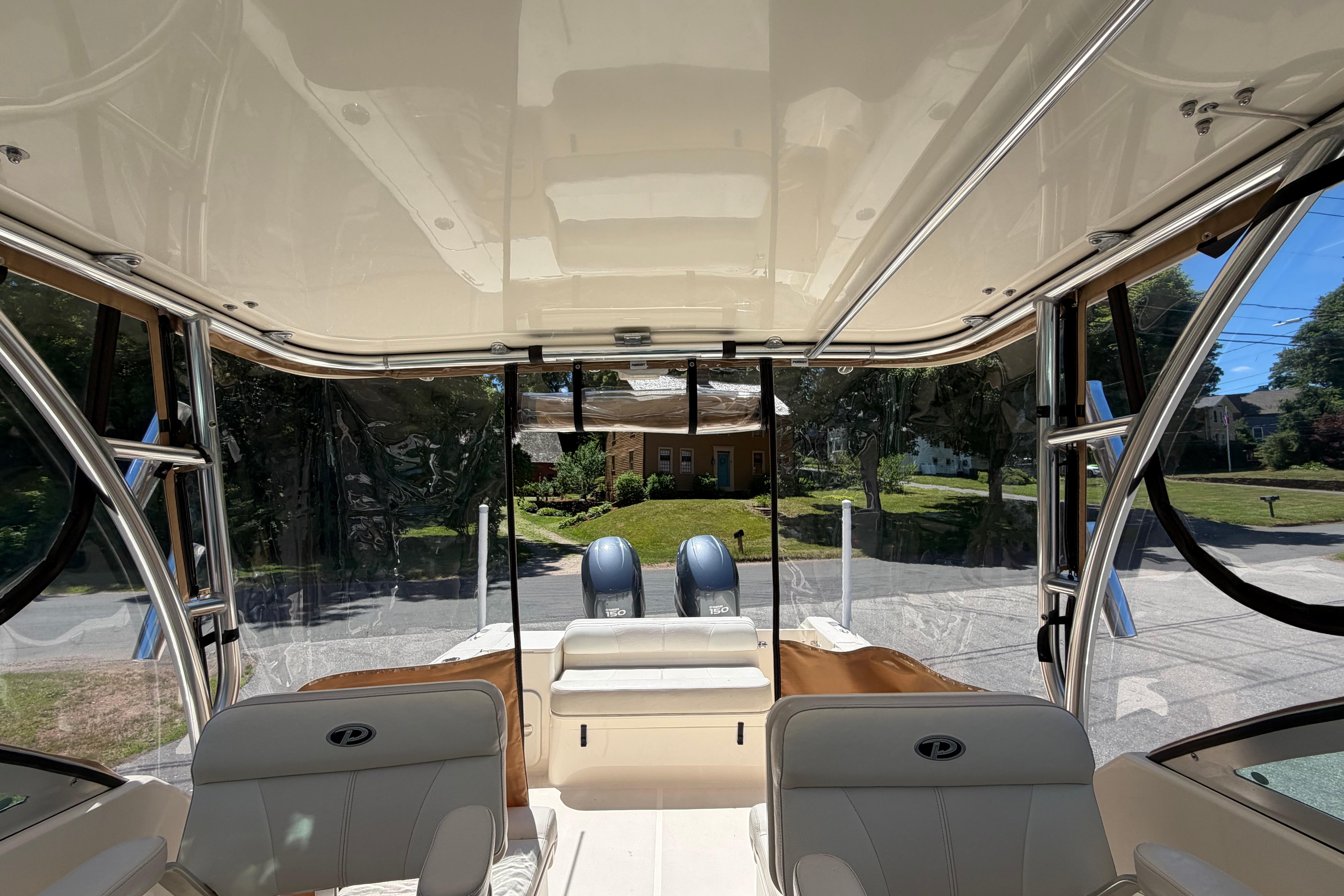 Interior view of 2010 Pursuit OS 255 Offshore boat, showcasing seating and helm area.