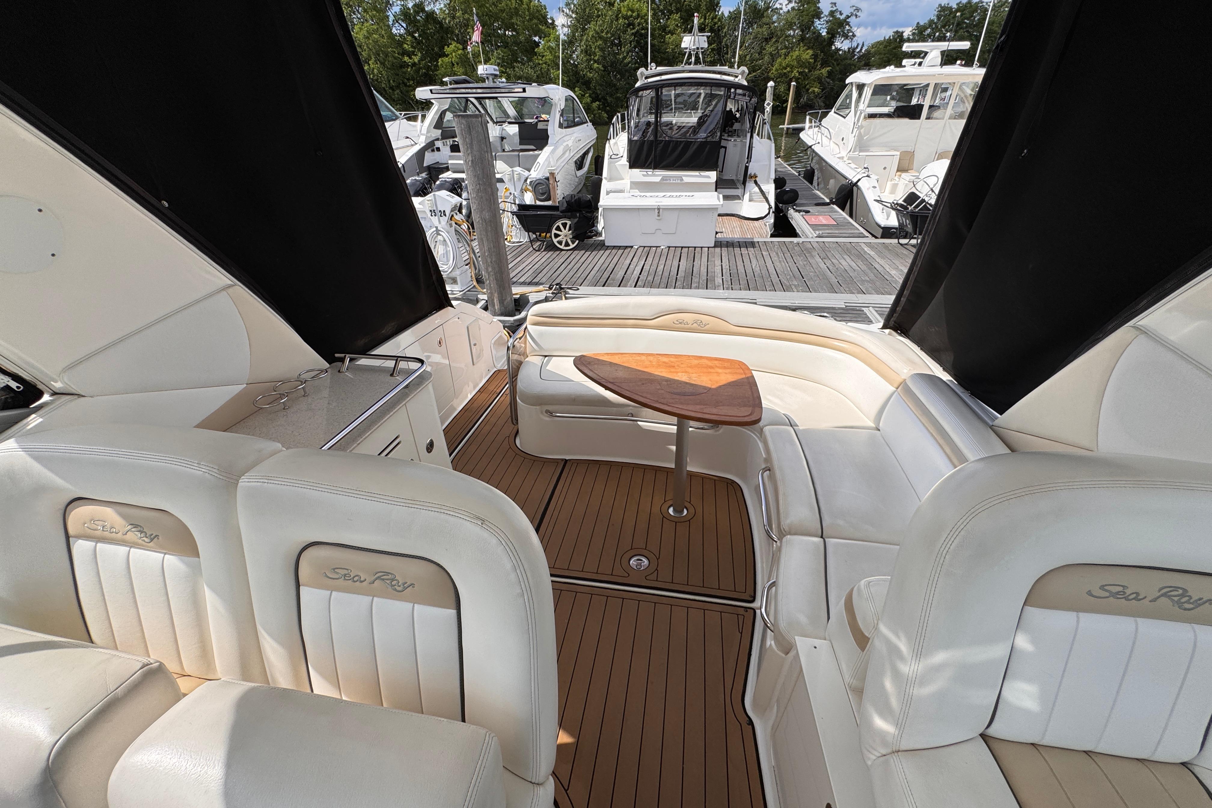 Interior view of 2008 Sea Ray Sundancer 350 yacht with elegant seating and wooden table.