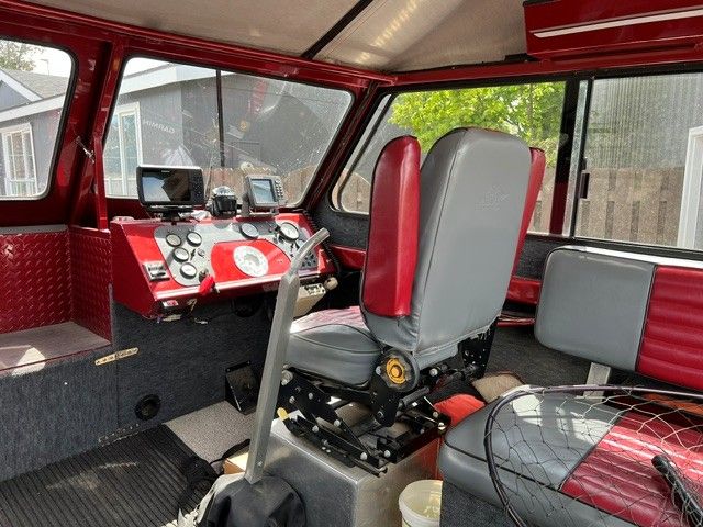 Interior of a 1996 Northwest Signature boat with red and gray seating.