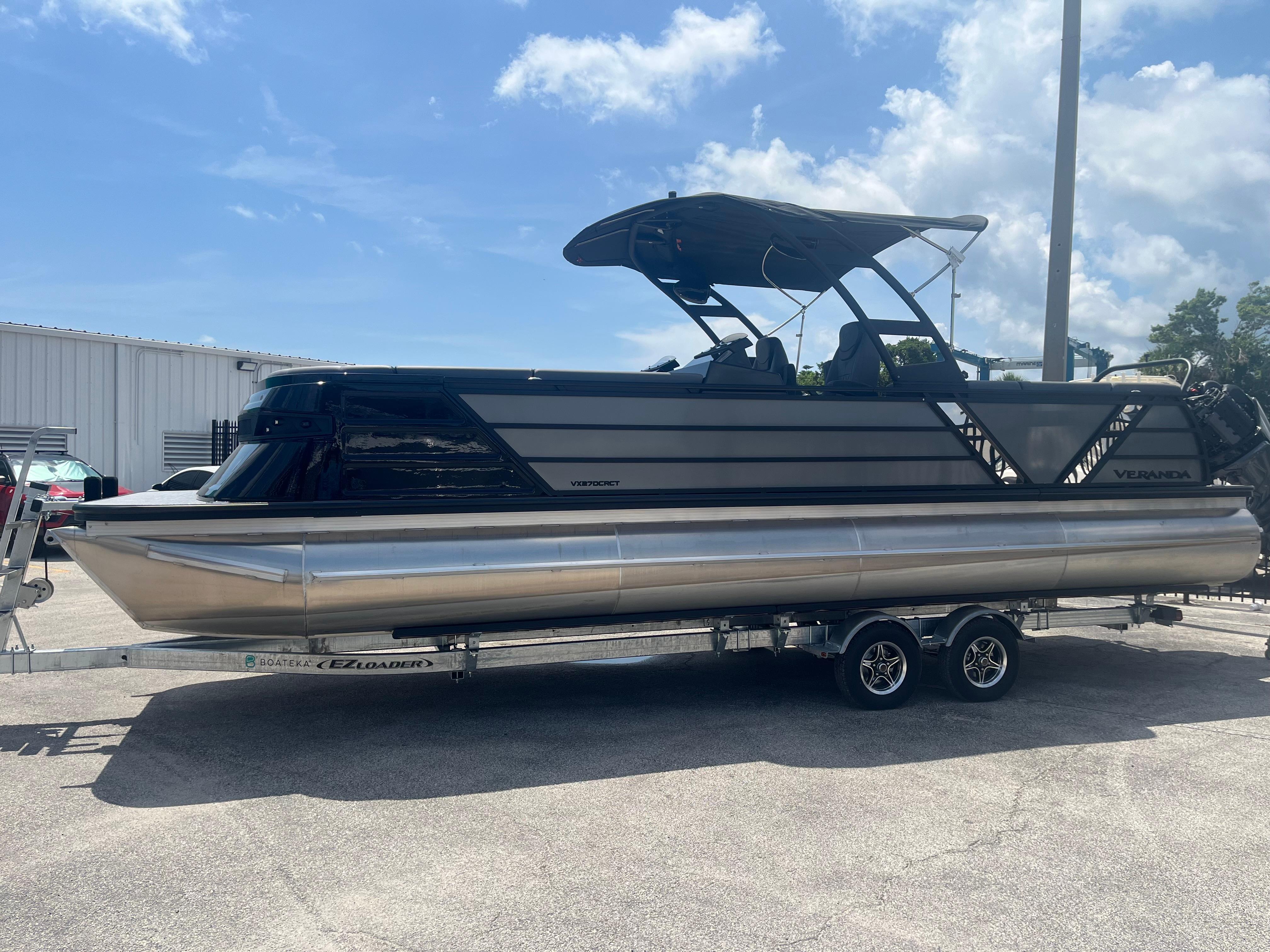 2025 Veranda VX 27 DCRC pontoon boat on trailer under clear sky.