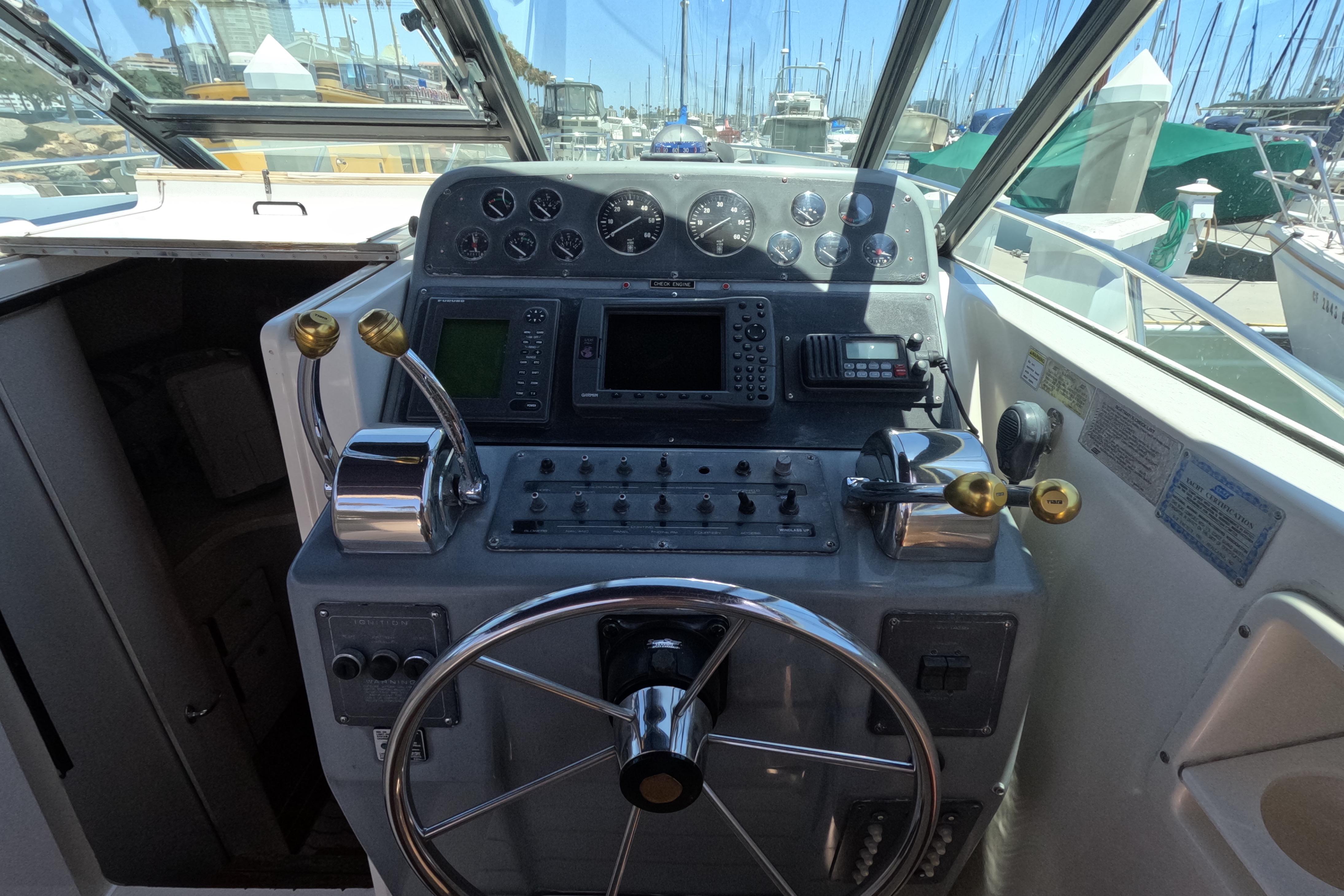 1995 Tiara Yachts 2900 Open helm with steering wheel and control panel.