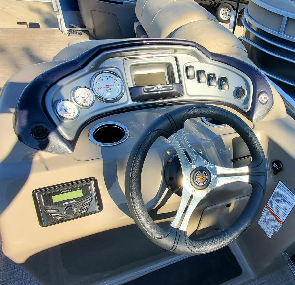 2023 Sun Tracker Party Barge 22 XP3 dashboard with steering wheel and control panel.