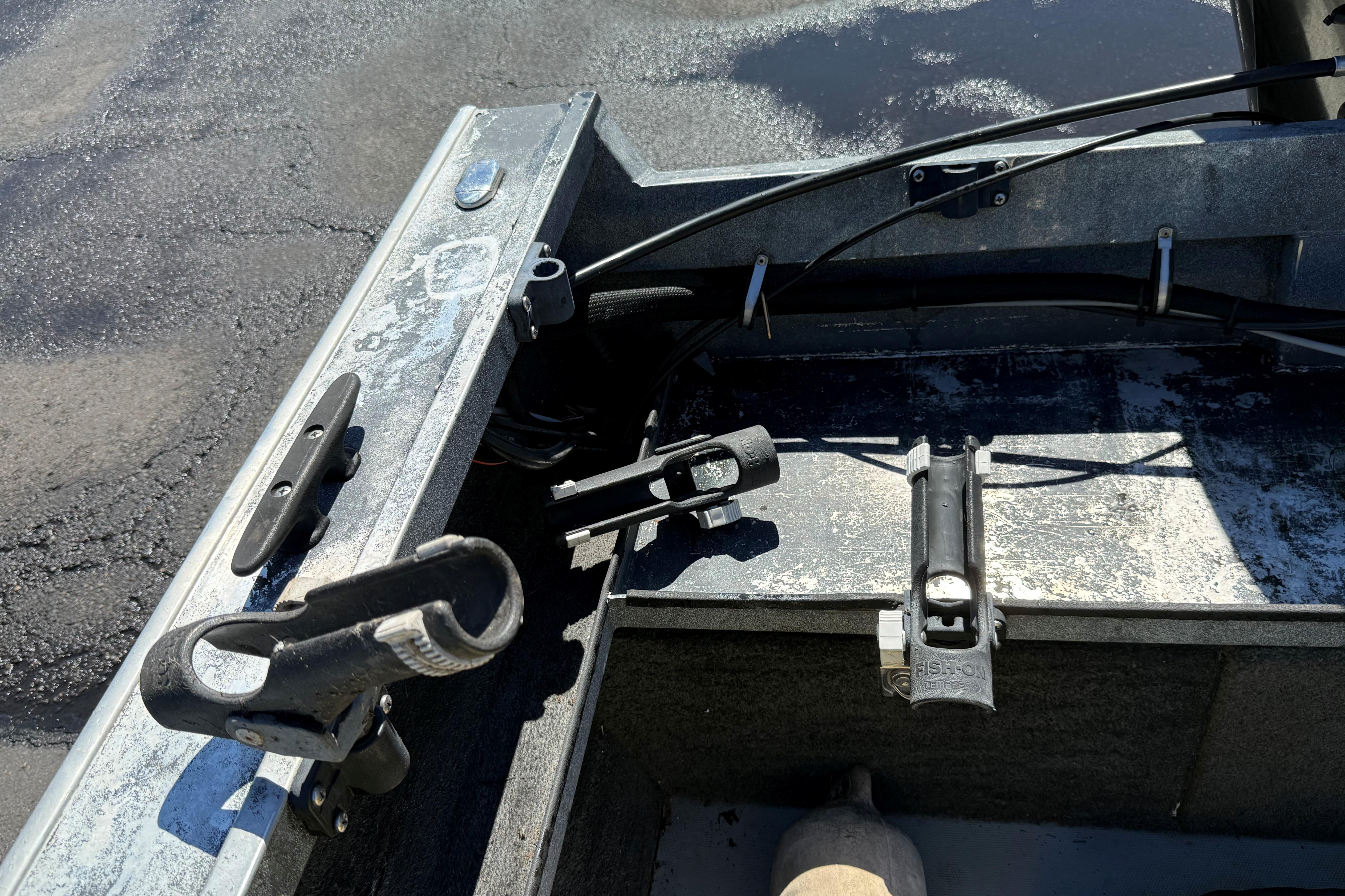 2004 Alumaweld Intruder Outboard 20 boat interior with rod holders and cleats.
