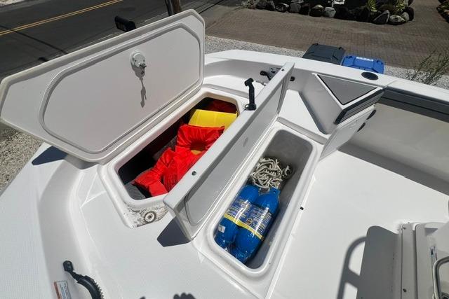 2019 Yamaha Boats 190 FSH Sport storage compartments with safety gear and ropes.