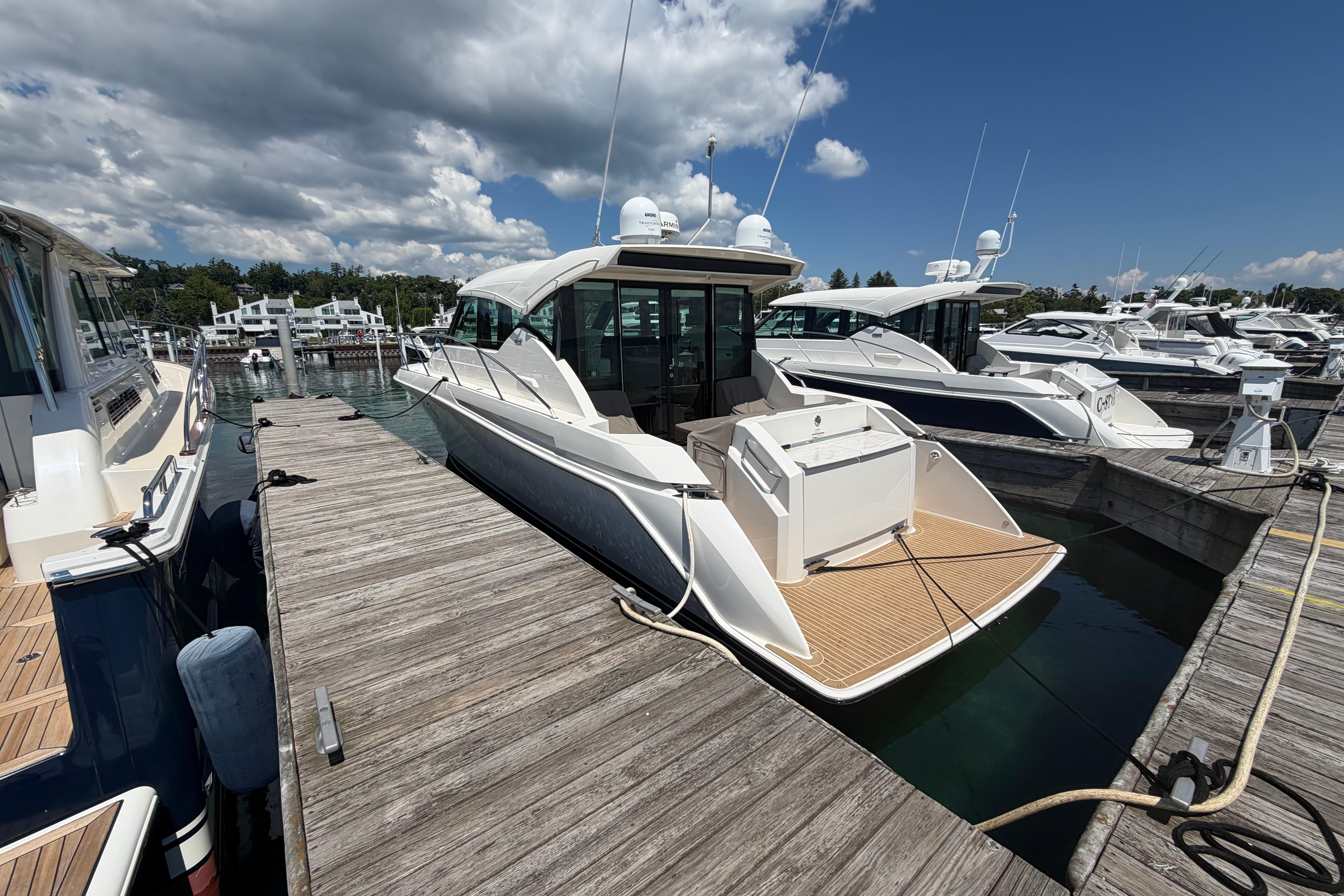 2016 Tiara Yachts C39 Coupe docked at marina under blue sky.