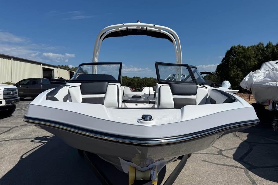 2026 Yamaha Boats 195S, sleek white design, parked outdoors under clear blue sky.